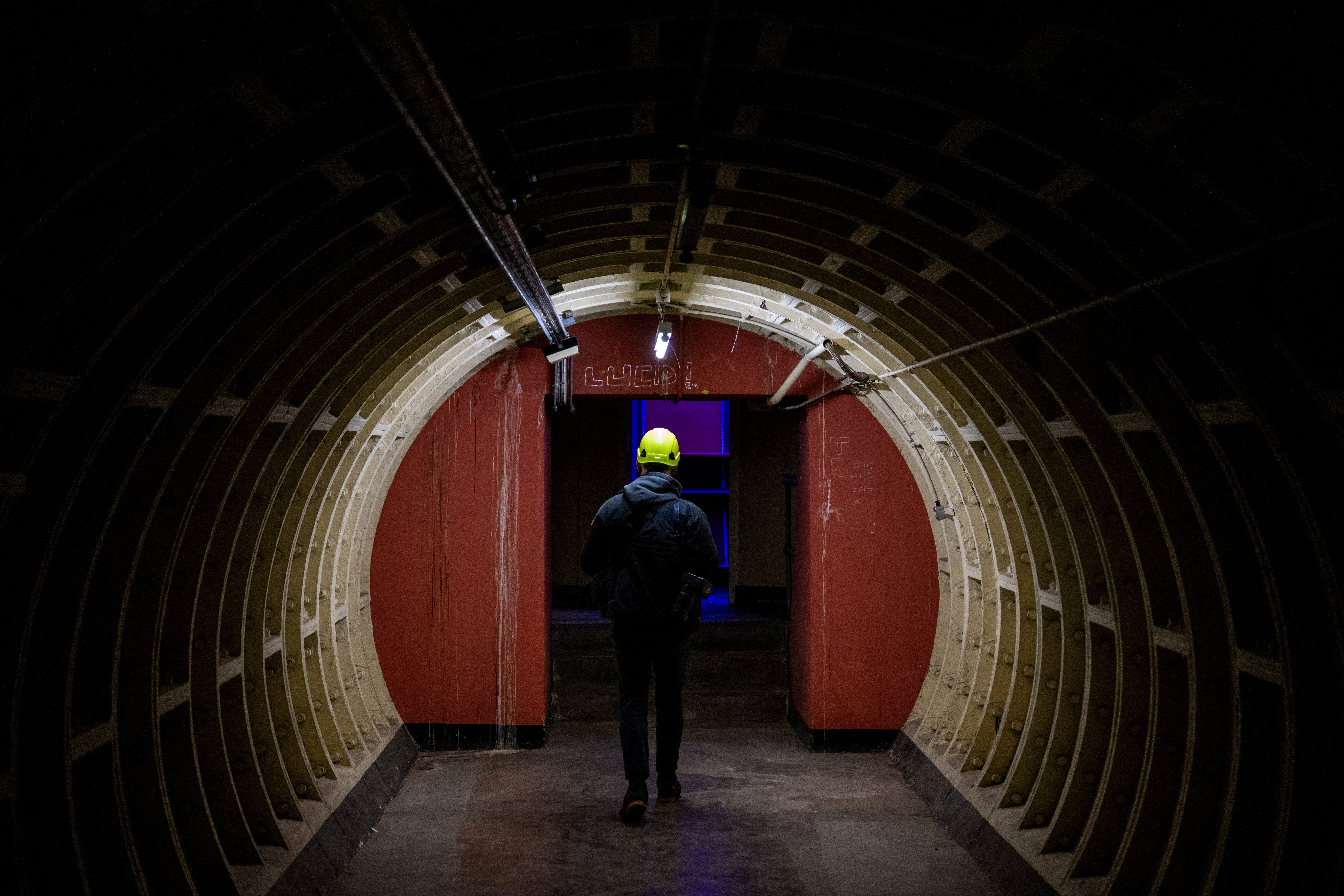 A journalist walks during a press tour of underground tunnels used during World War Two as shelters during the Blitz that are now due be developed into a new tourist attraction called The London Tunnels