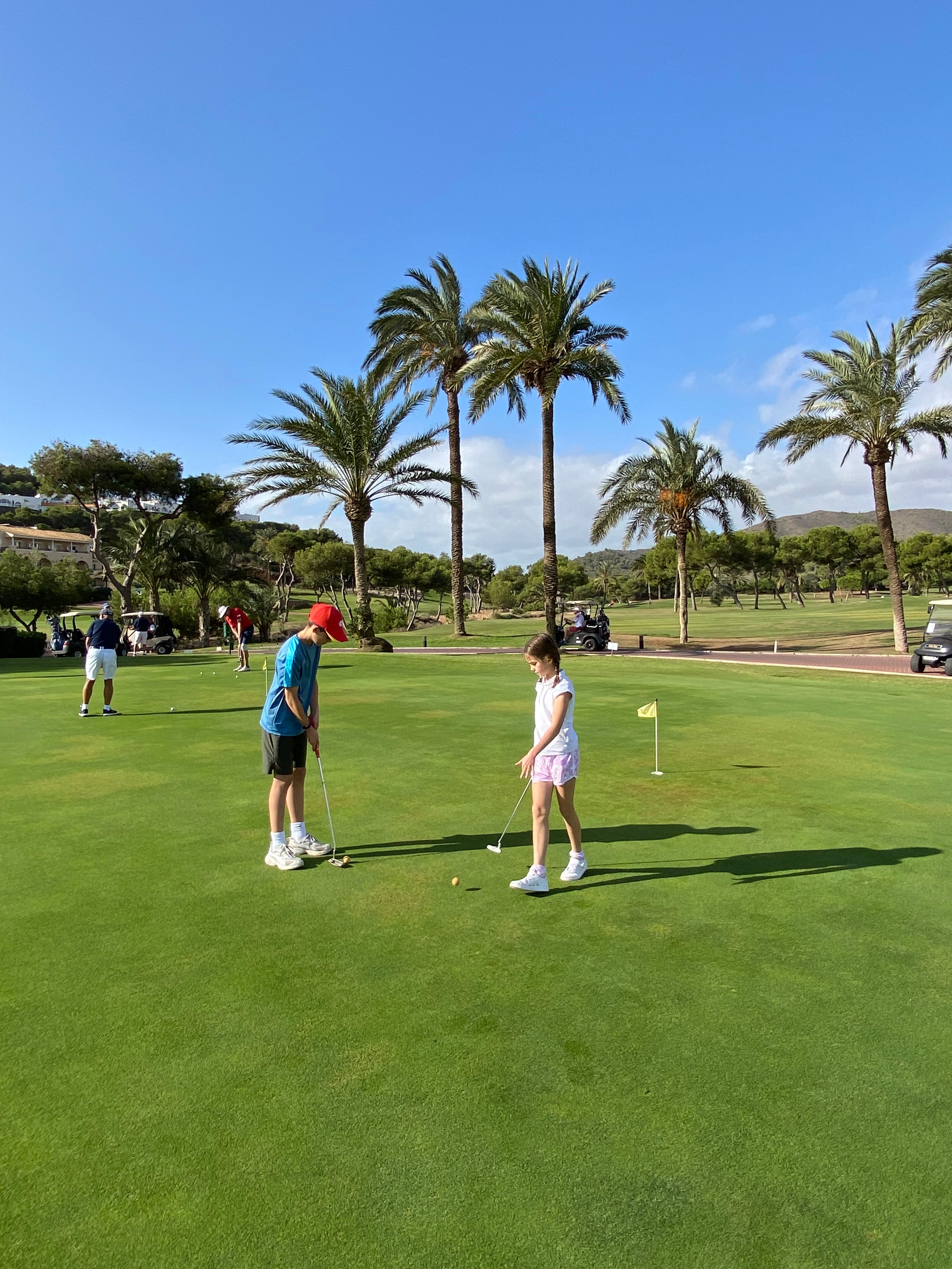 Serious players mingle with young novices on the practice greens
