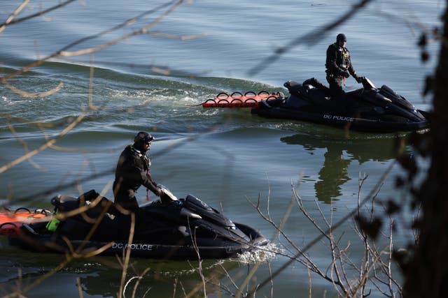 <p>Washington, D.C., police help to investigate near the crash site of the American Airlines plane on the Potomac River on Thursday in Arlington, Virginia. Crews searching for the victims of the crash will have to face near-freezing waters, leading to concerns about health impacts</p>