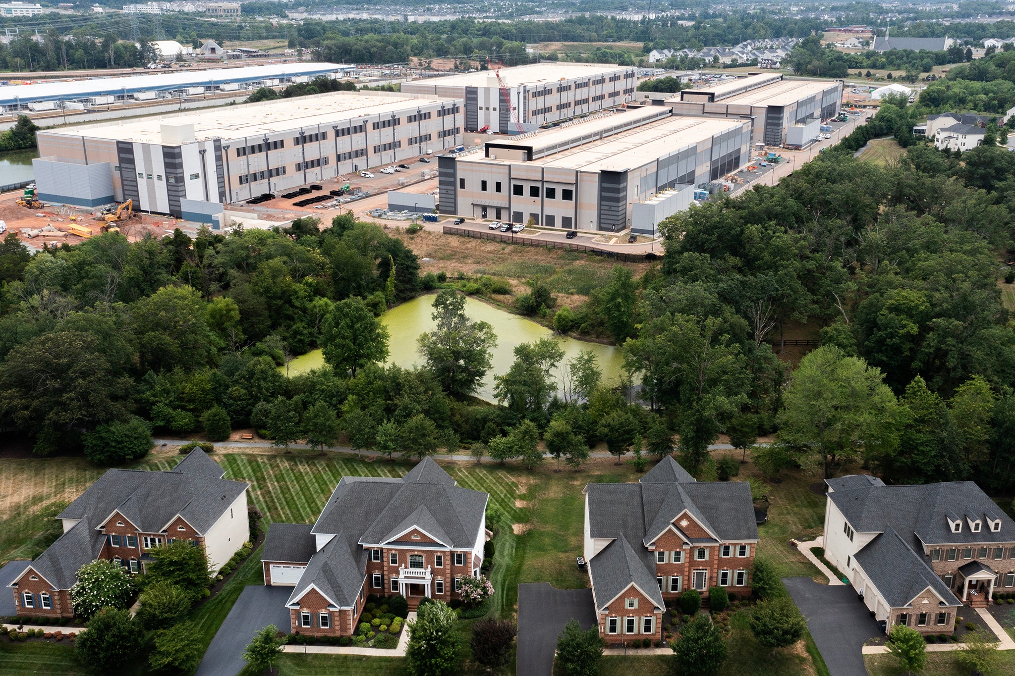 An Amazon Web Services data center is shown situated near single-family homes on July 17, 2024 in Stone Ridge, Virginia. Loudon County, where Stone Ridge is located, is home to 199 data farms as of early 2025, earning it the name “Data Center Alley”