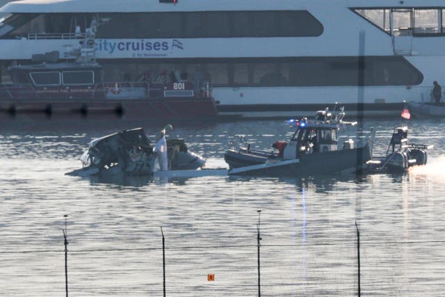 <p>Rescue crews search the Potomac River the day after an American Airlines plane collided with a US Army Black Hawk helicopter, killing 67 people</p>