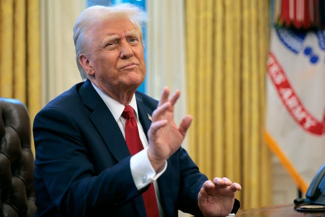 <p>President Donald Trump reacts to a reporter's question from the Resolute Desk after signing an executive order Thursday</p>