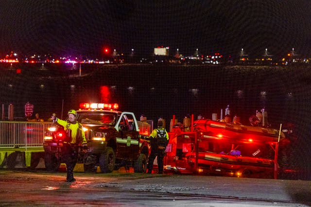 <p>Rescue teams organize to help search the Potomac River after an American Airlines passenger plane collided with a military helicopter on approach to Ronald Reagan National Airport in Washington, D.C.</p>