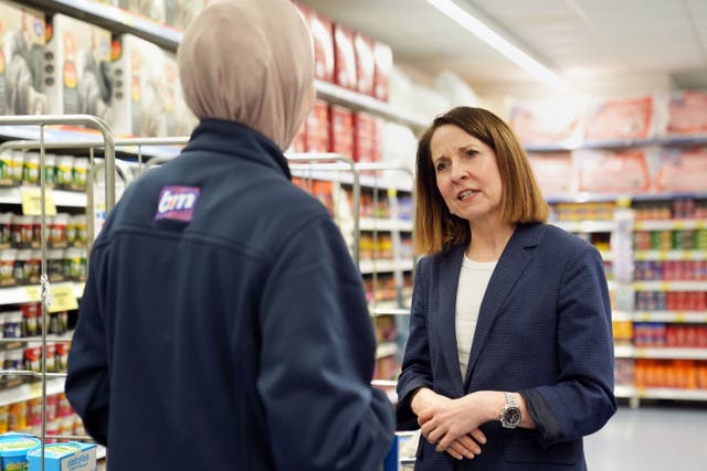 Work and Pensions Secretary Liz Kendall talks to a staff member during a visit to a B&M store in Bedford (Joe Giddens/PA)