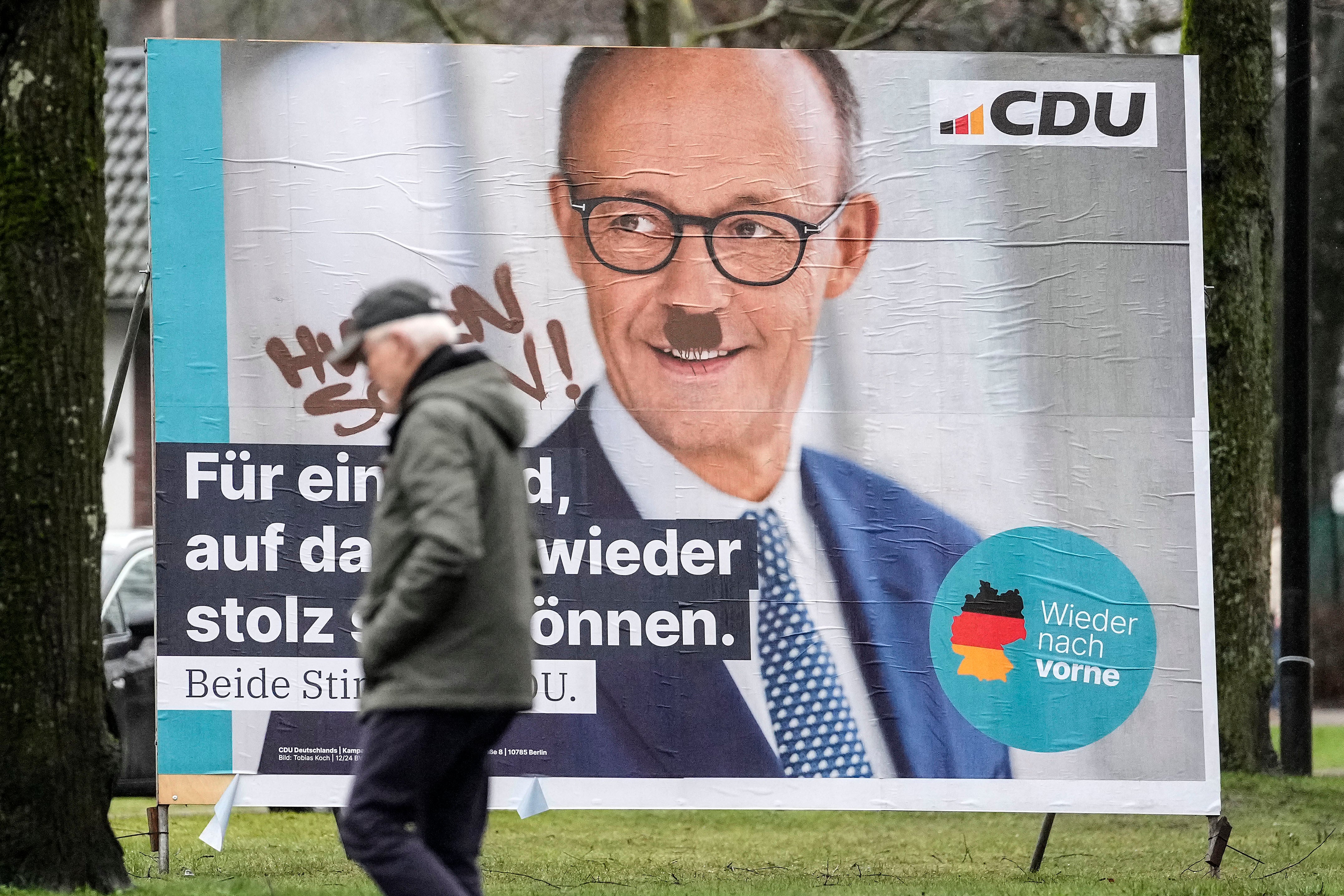 A poster for the Christian Democratic Union, featuring top candidate Friedrich Merz, has been defaced with a Hitler moustache