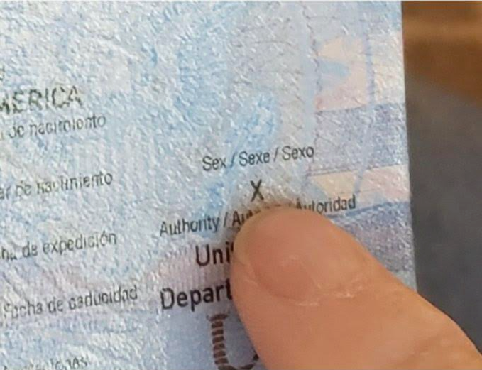 Dana Zzyym indicates the 'X' marker on their passport, a gender-neutral marker federal courts ruled would allow people to have more accurate legal documentation