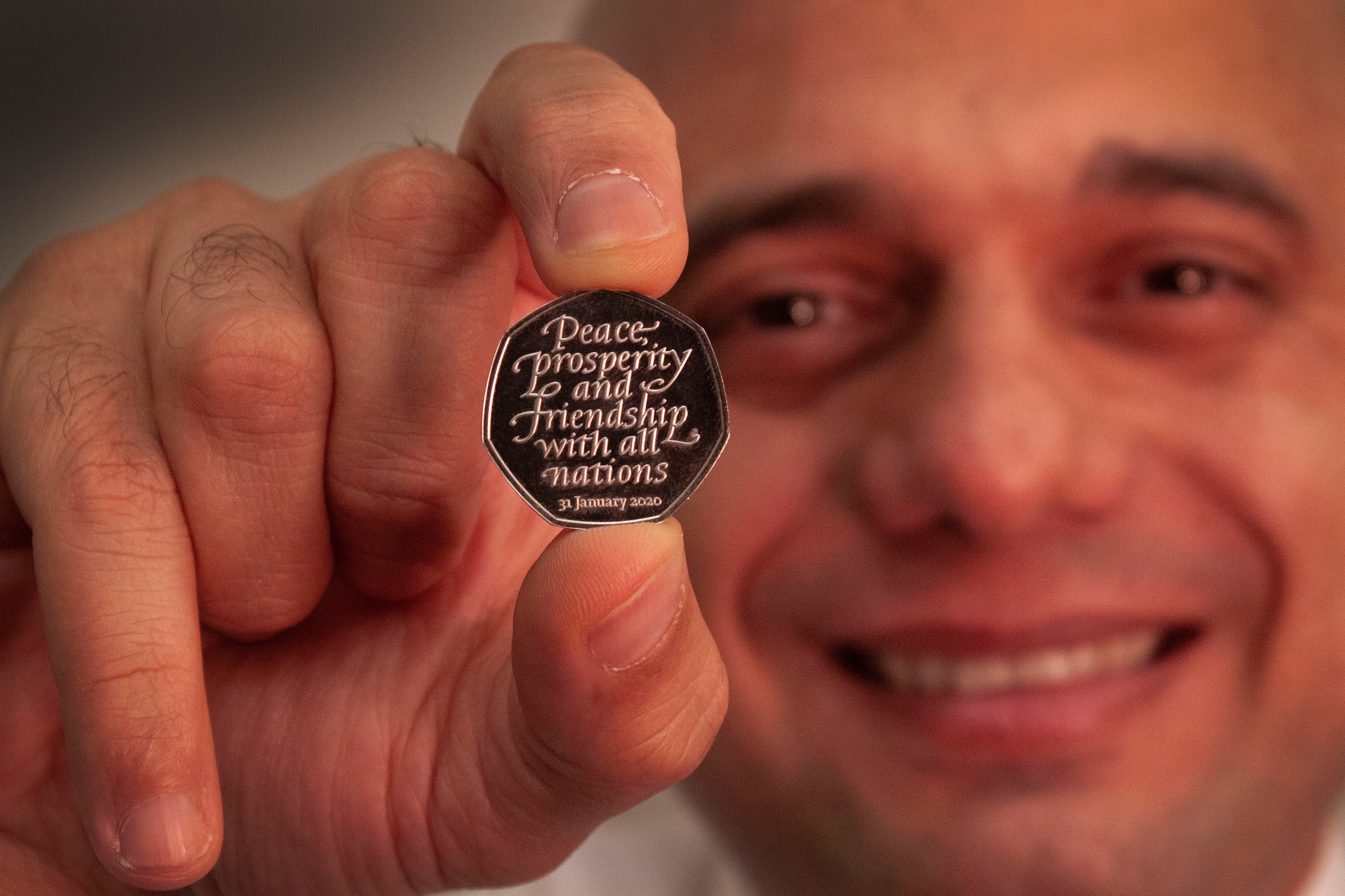 Former chancellor of the Exchequer Sajid Javid holding the Brexit coin