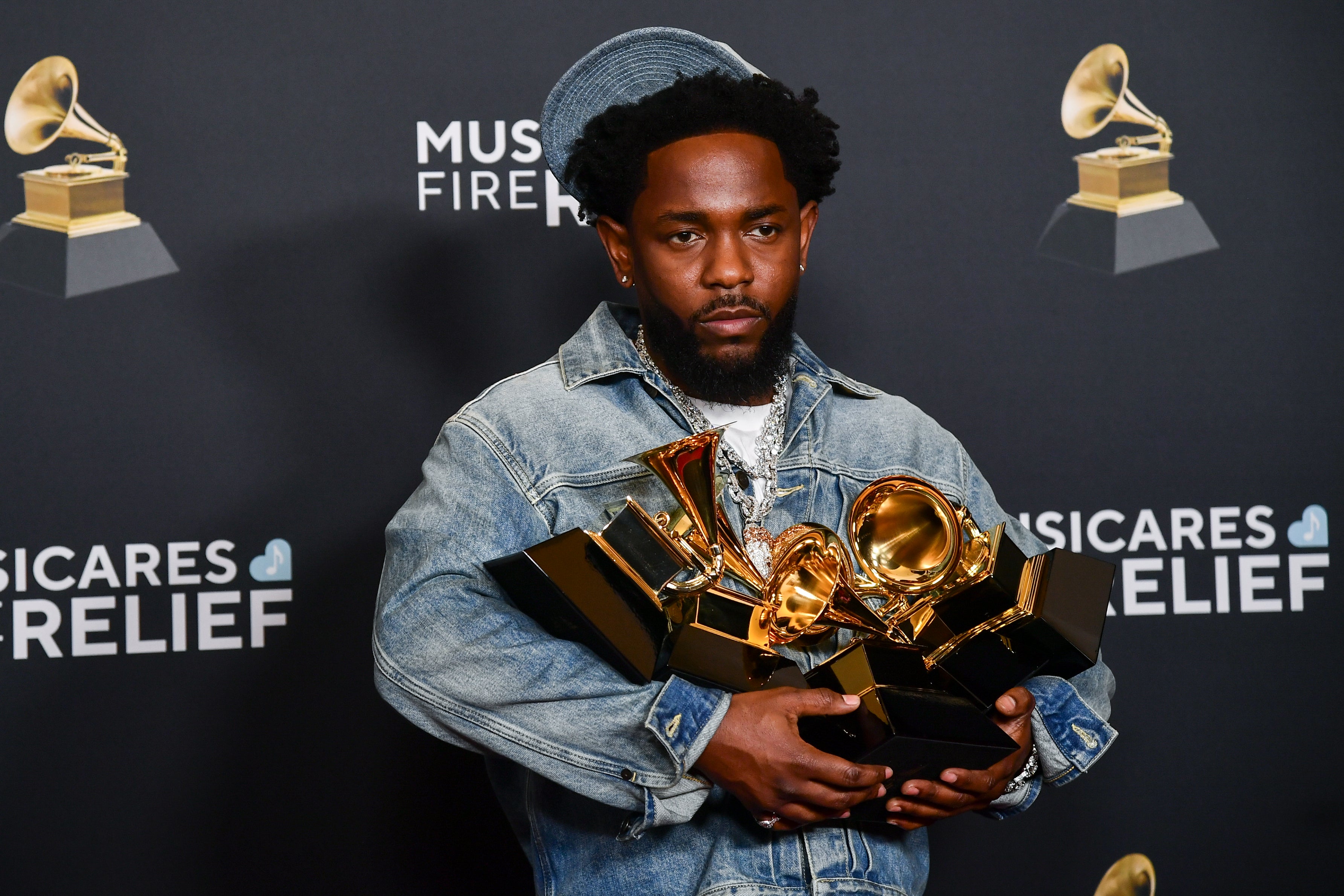 Kendrick Lamar poses in the press room with the award for Record of the Year, Best Rap Performance, Best Rap Song, Best Music Video and Song of the Year during the 67th annual Grammy Awards