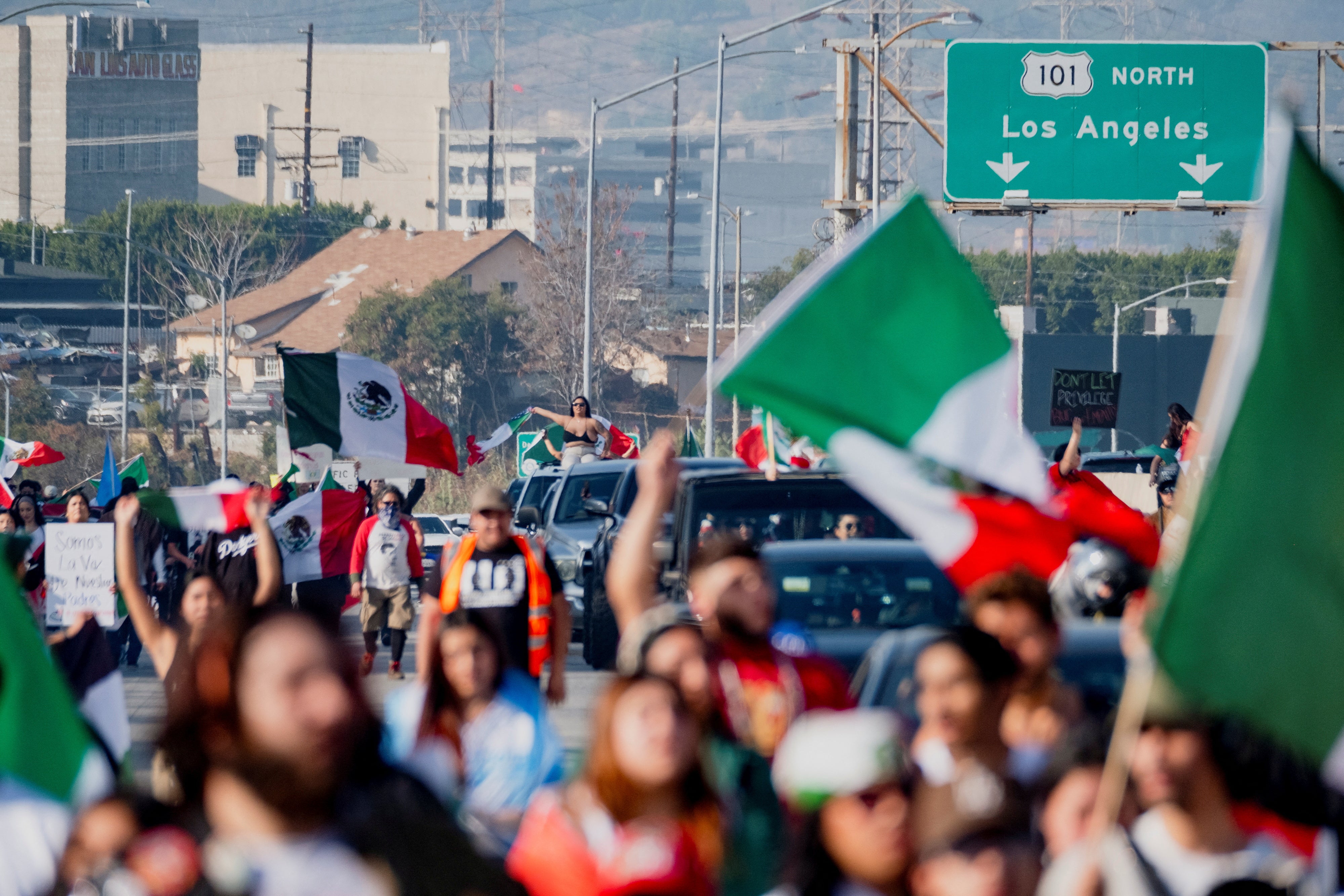 People march along Route 101 during a protest against arrests and deportations of migrants by government agencies in Los Angeles, 2 February
