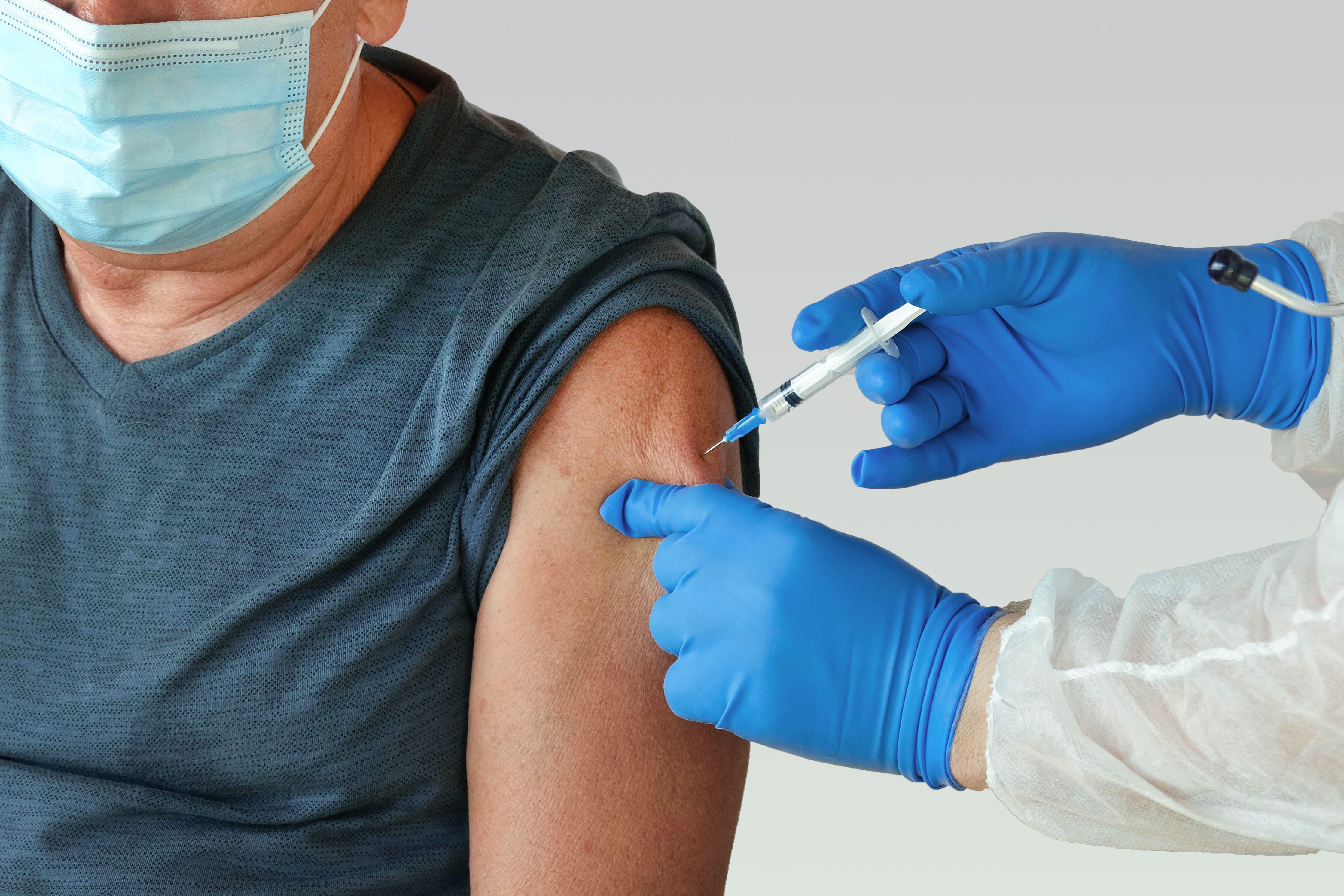 Doctor inserting mpox vaccine into senior man’s arm (Alamy/PA)