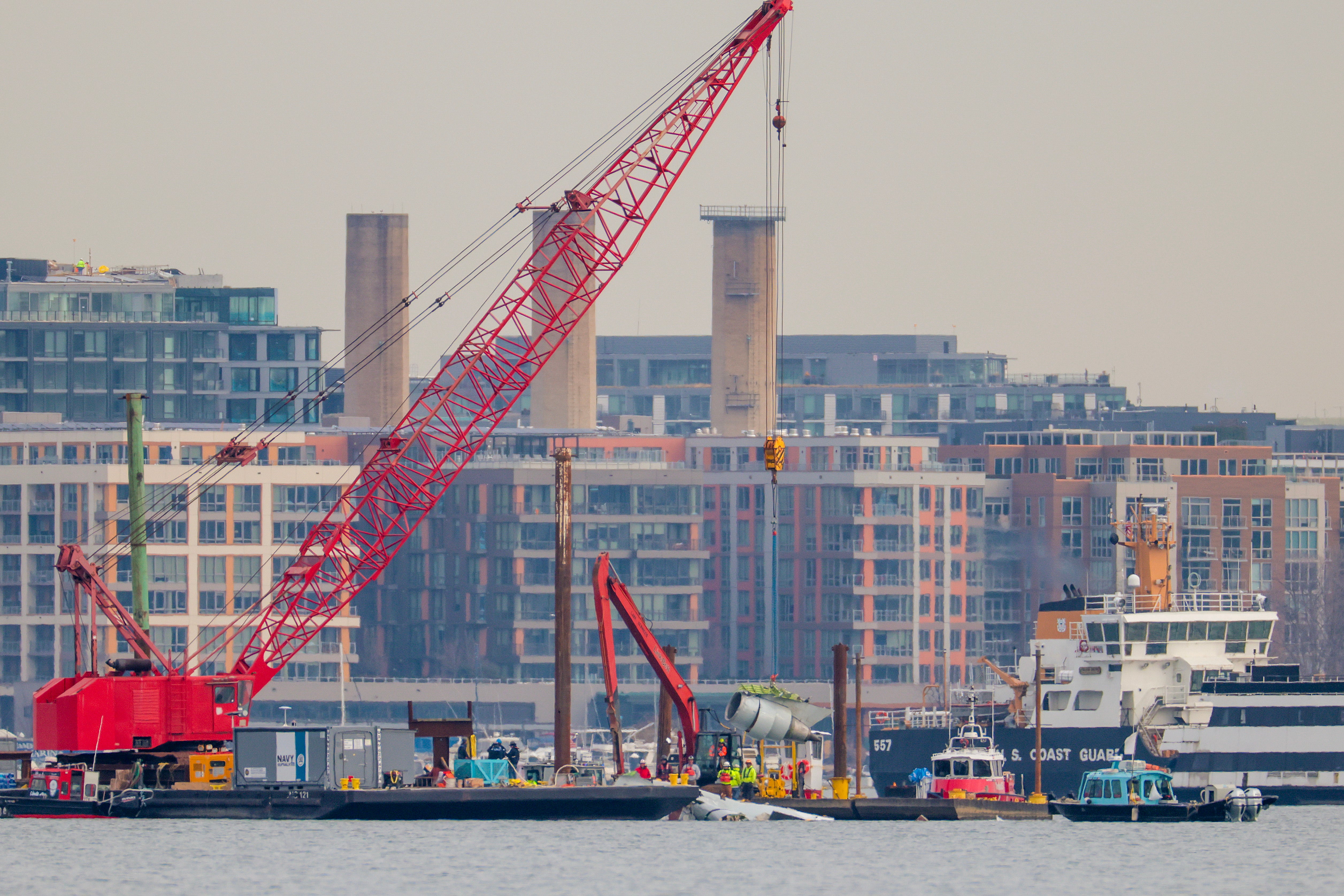A crane lifts a jet engine out of the Potomac River during recovery efforts after the American Airlines crash on February 03, 2025 in Arlington, Virginia