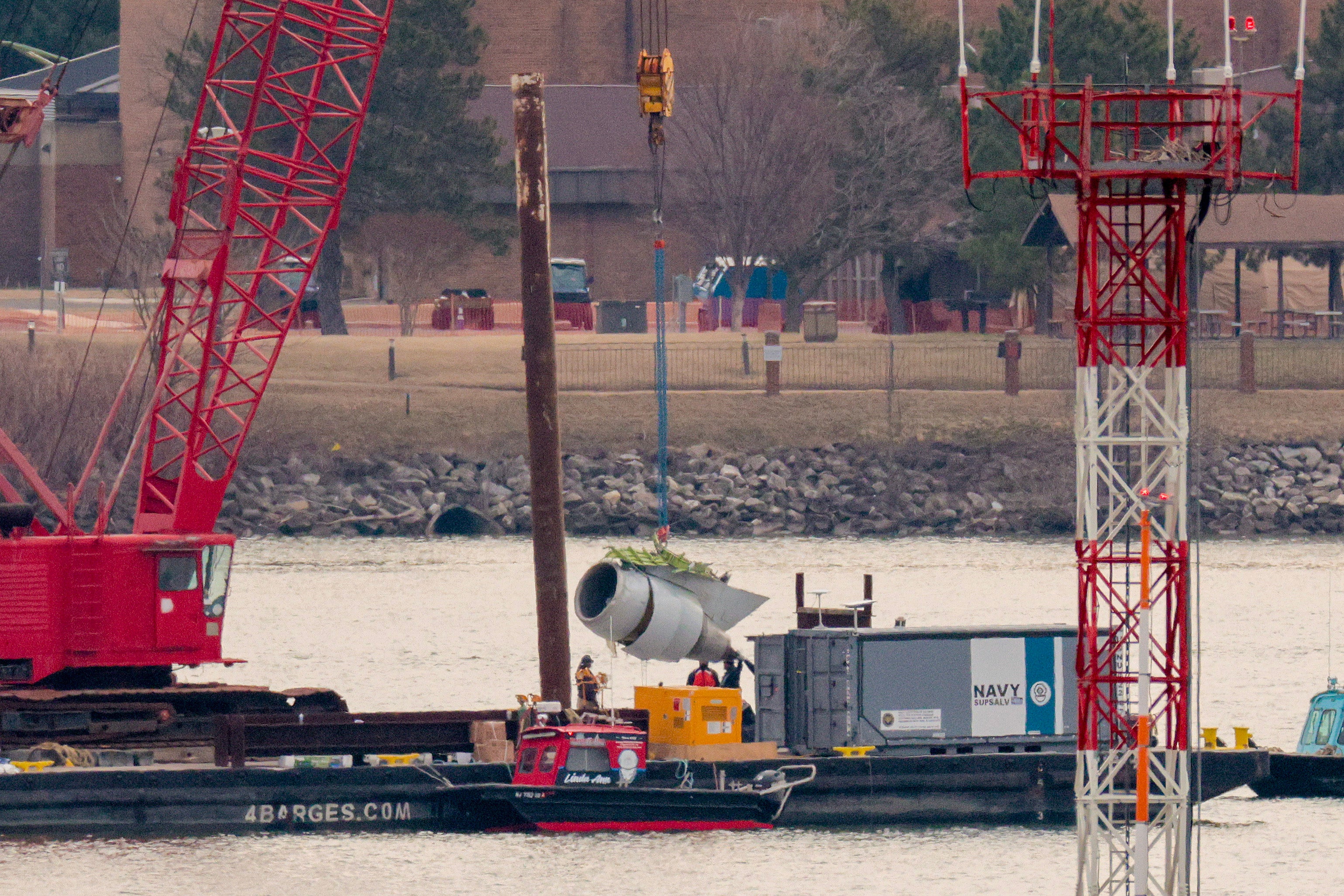 A crane lifts a pitchy motor retired of nan Potomac River during betterment efforts aft a mid-air collision adjacent Washington, D.C.