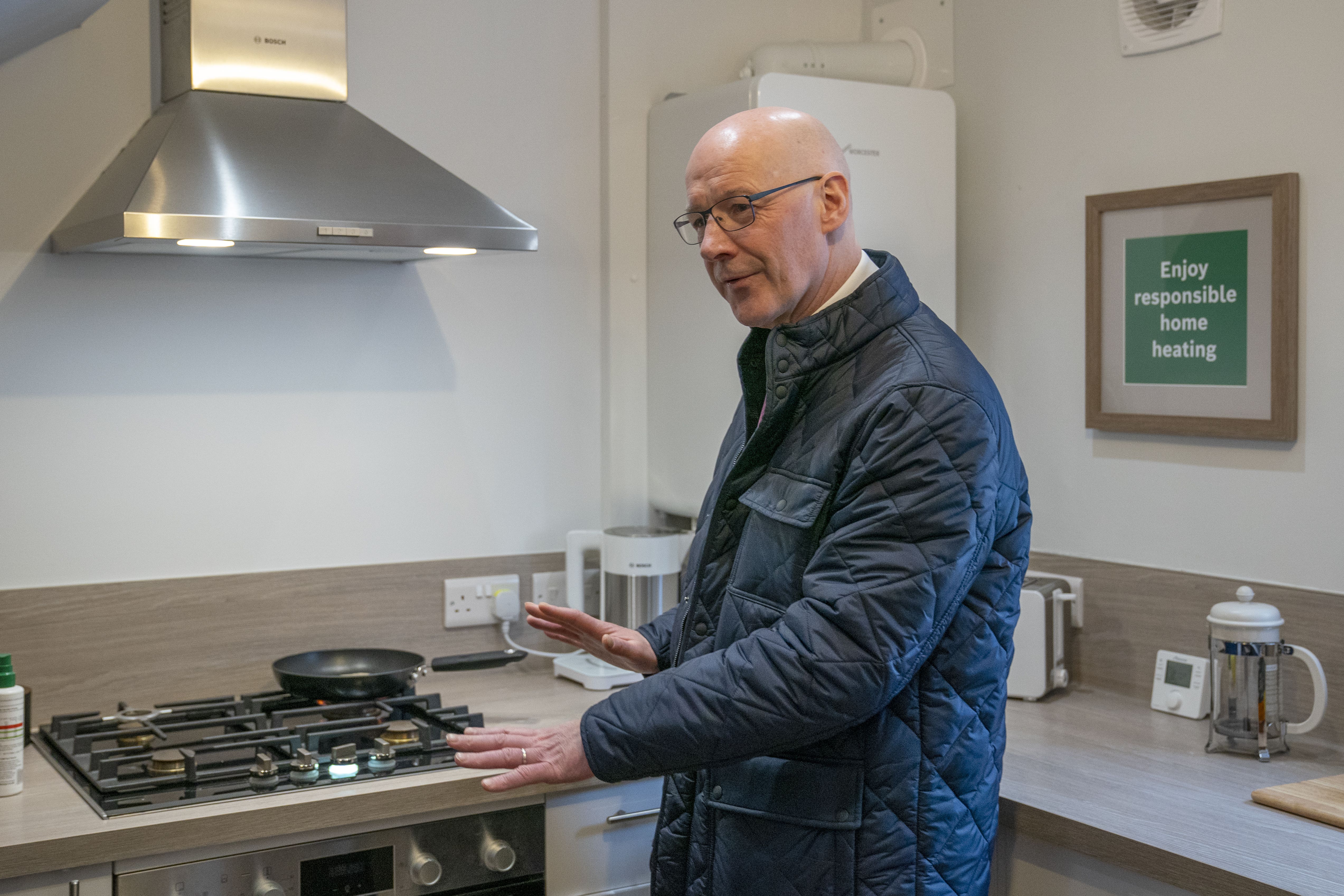 First Minister John Swinney was shown a hydrogen gas cooker during the visit (Jane Barlow/PA)