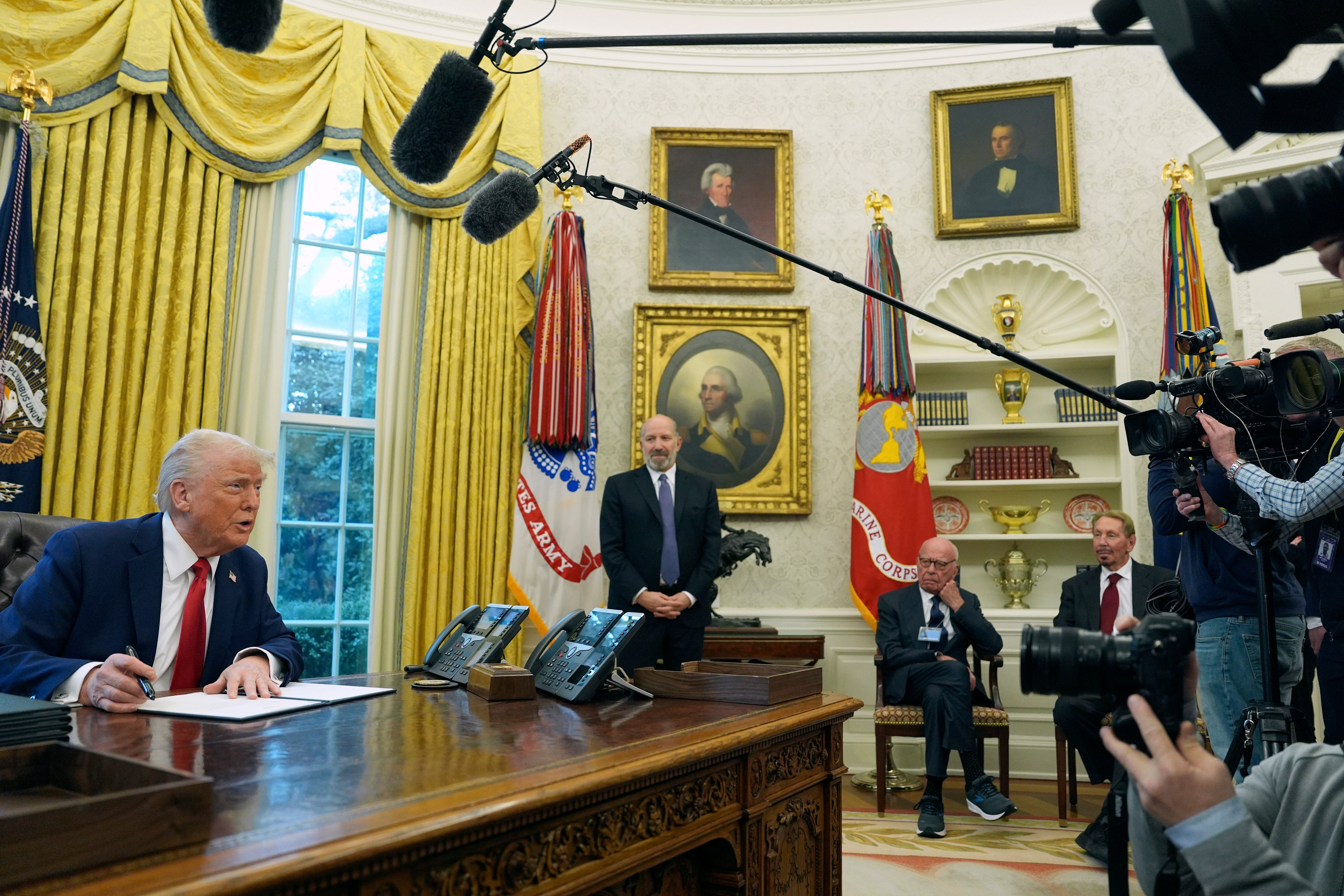 President Donald Trump signed executive orders on creating a sovereign wealth fund as Rupert Murdoch looks on.