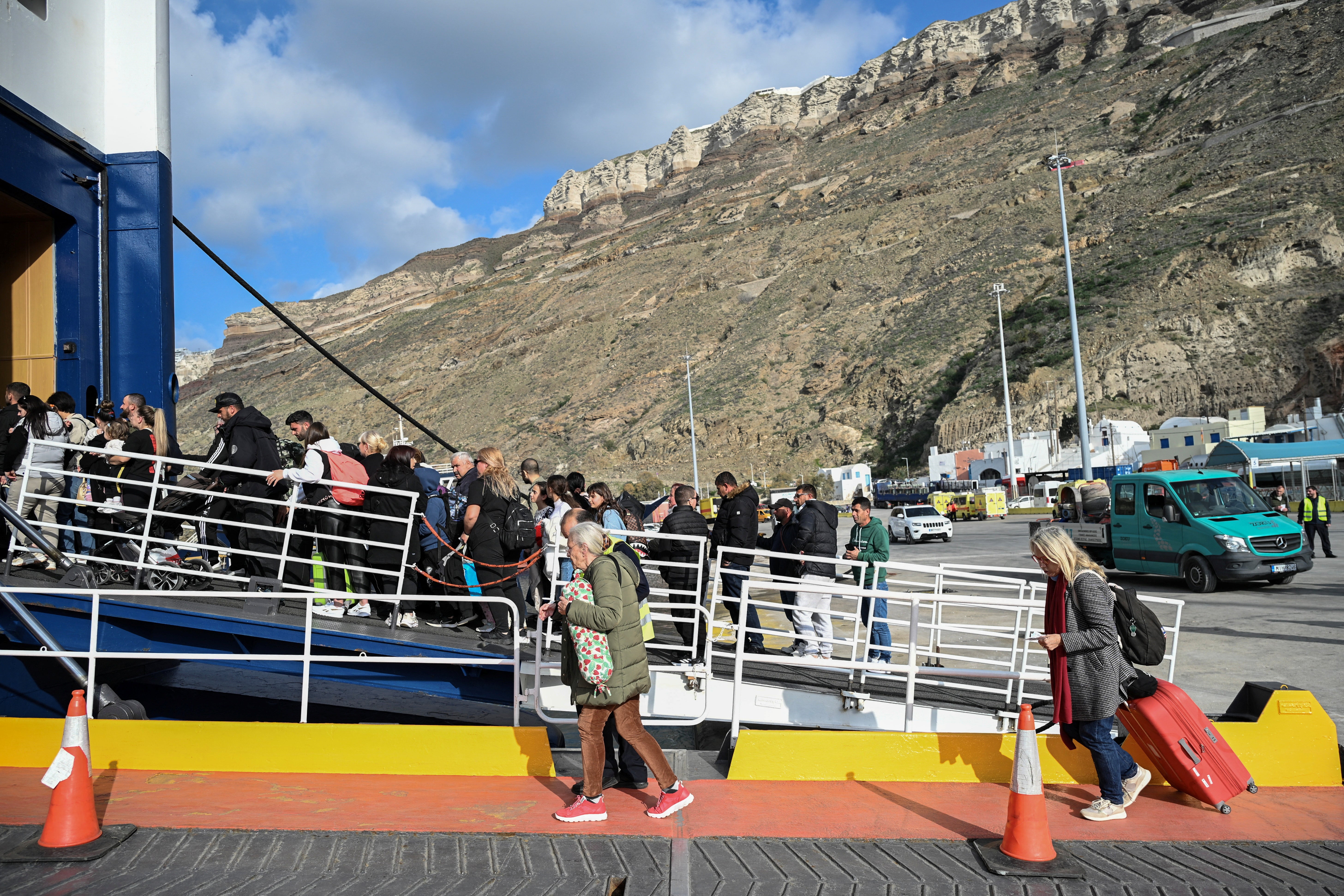 Passengers board a ferry as they leave following high seismic activity, on the island of Santorini, Greece, February 3, 2025