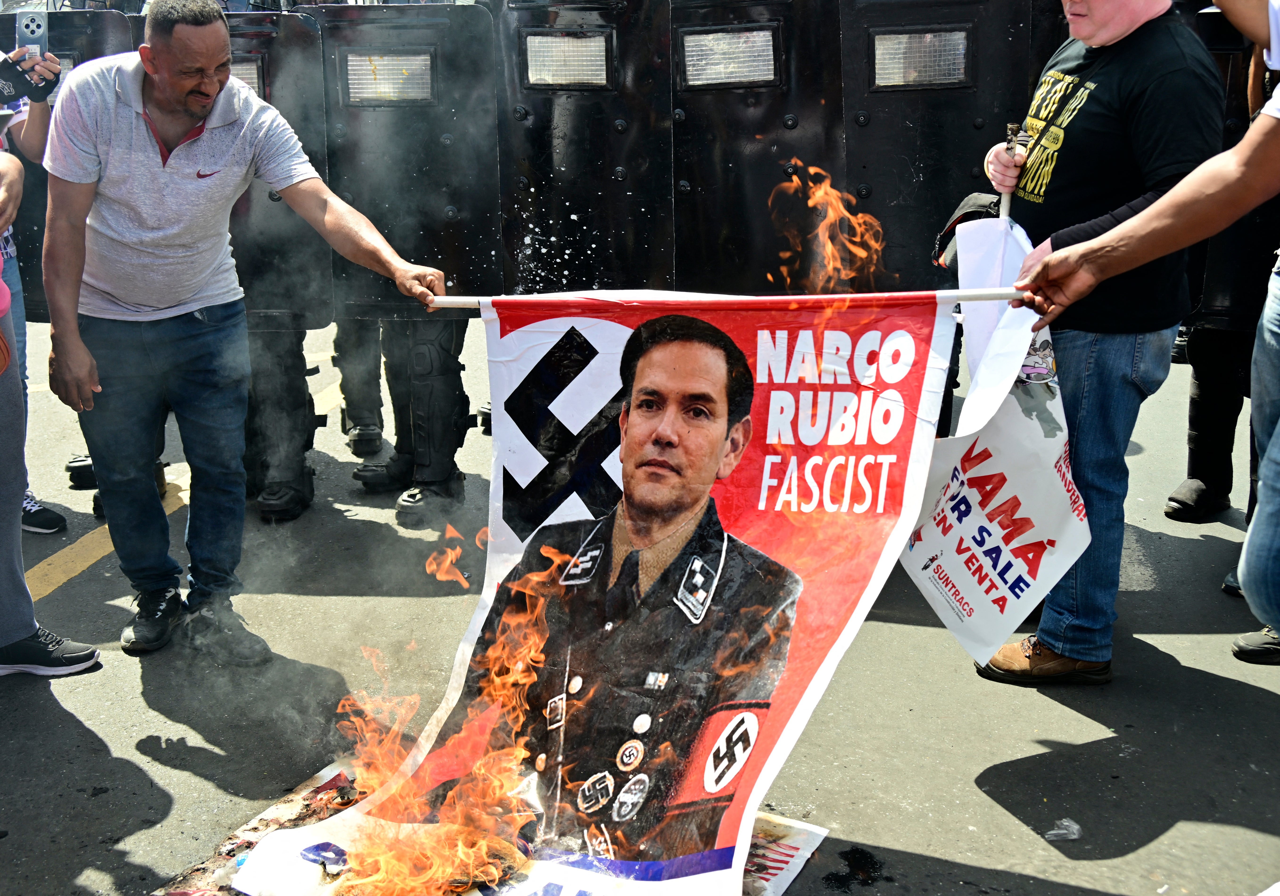 Demonstrators burn an allusive sign during a protest against the visit of US secretary of state Marco Rubio in Panama City