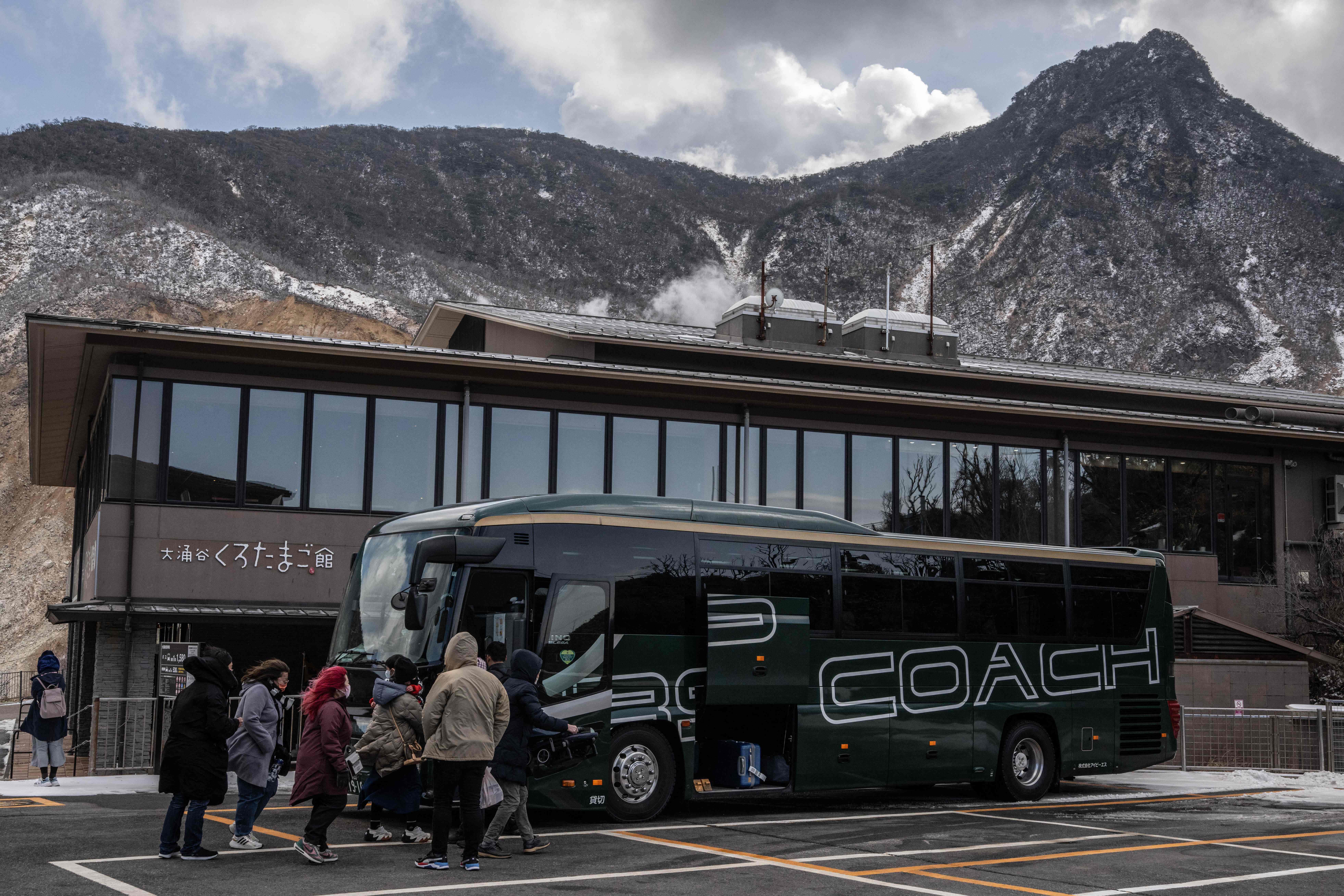 <p>Representational: This picture taken on 1 February 2023 shows tourists boarding a bus at the Owakudani volcanic valley in Hakone, Kanagawa prefecture</p>