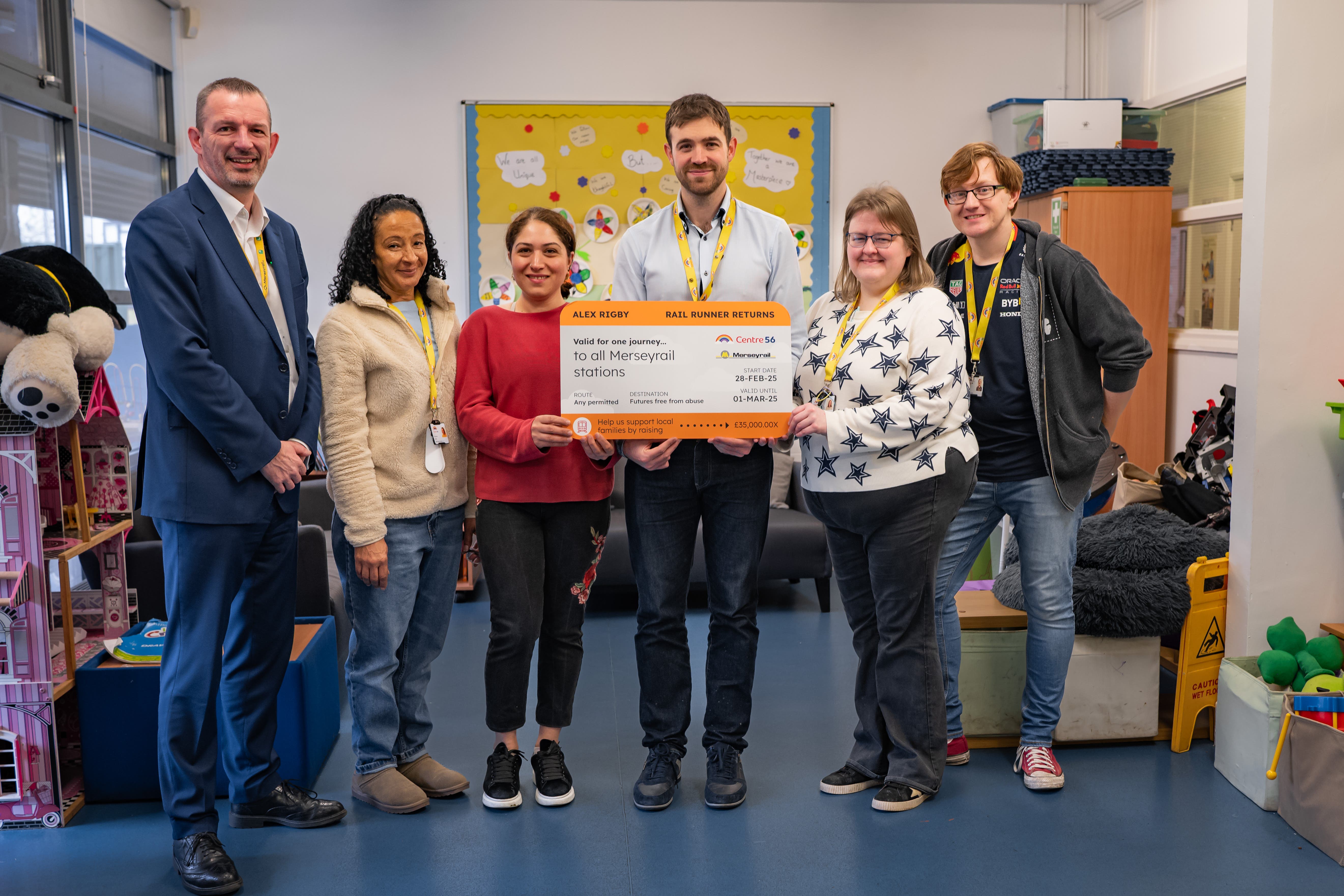 Alex Rigby (centre) is planning to run to every station on the Merseyrail network (Al Stirling Creative Content Design/PA)