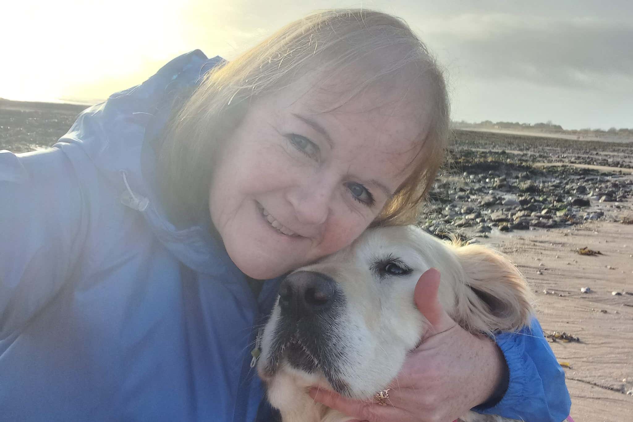 Andrea Phillips with Seren, a three-year-old golden retriever who was rescued by Porthcawl RNLI (Phillips family handout/PA)