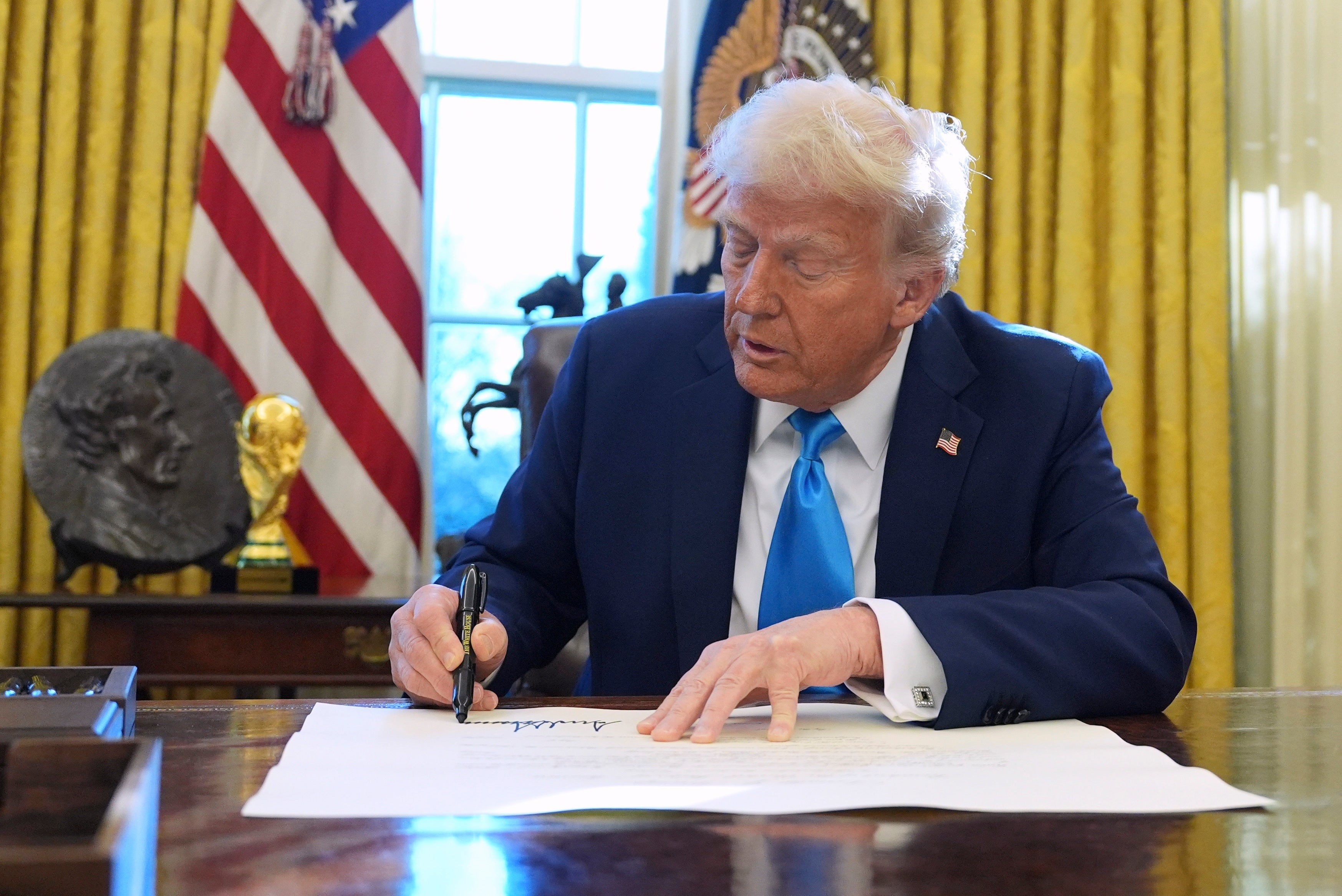 The Fifa World Cup trophy can be seen on Trump’s desk