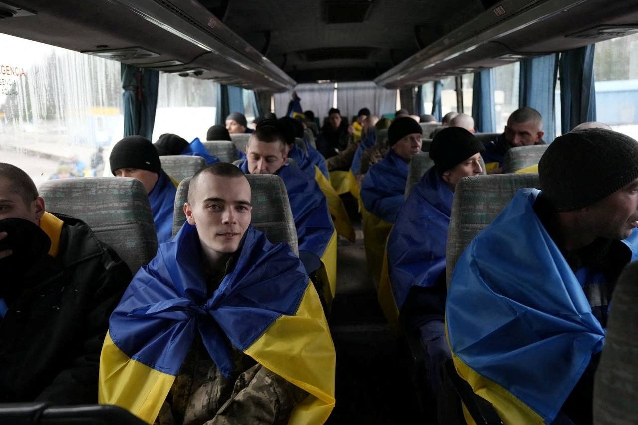 Ukrainian prisoners of war (PoWs) are seen inside a bus after a swap in an undisclosed location in Ukraine