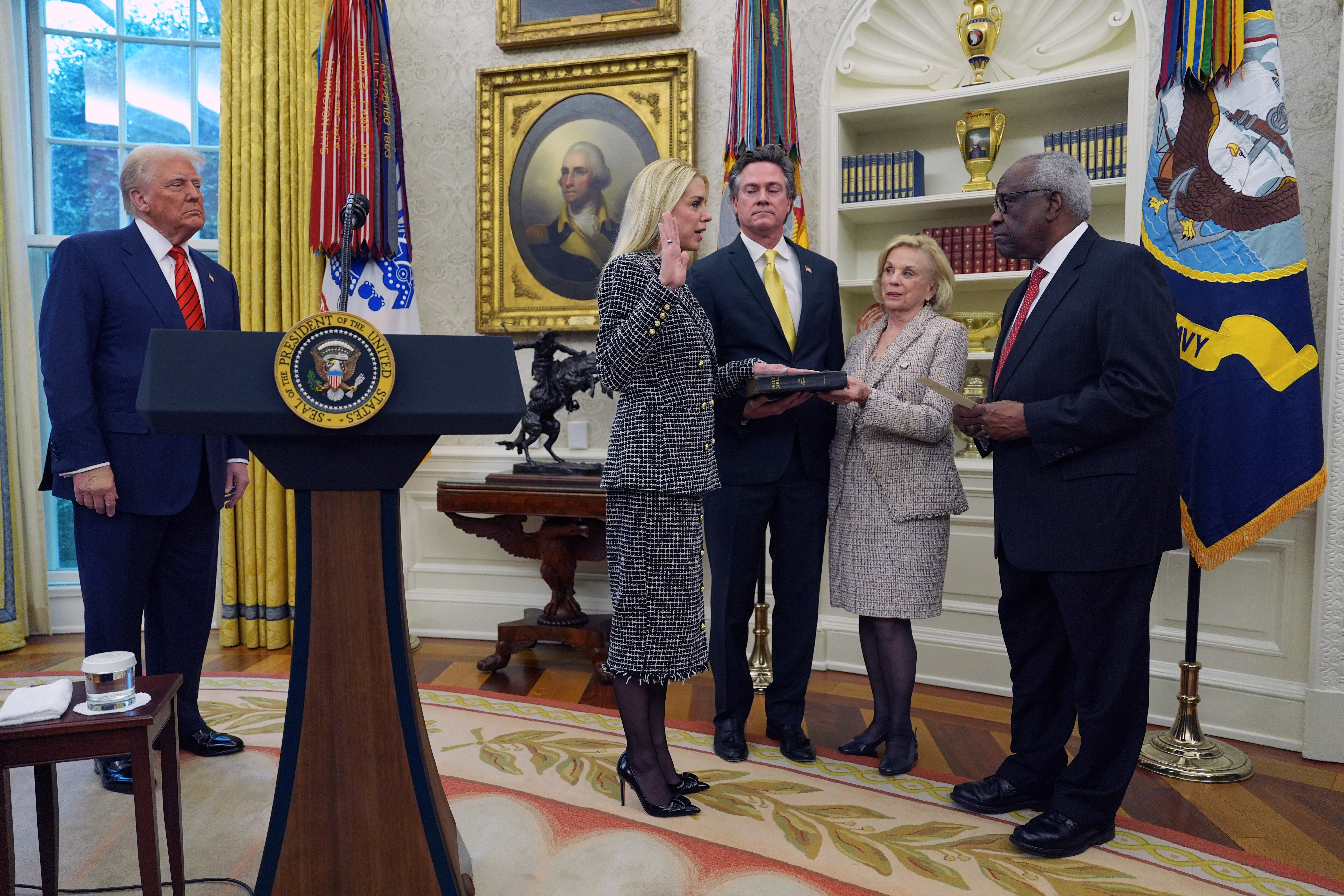 Bondi is sworn in as attorney general by Supreme Court Justice Clarence Thomas (right) as President Donald Trump, partner John Wakefield and mother Patsy Bondi, look on, in the Oval Office. She issued several orders on her first day in office