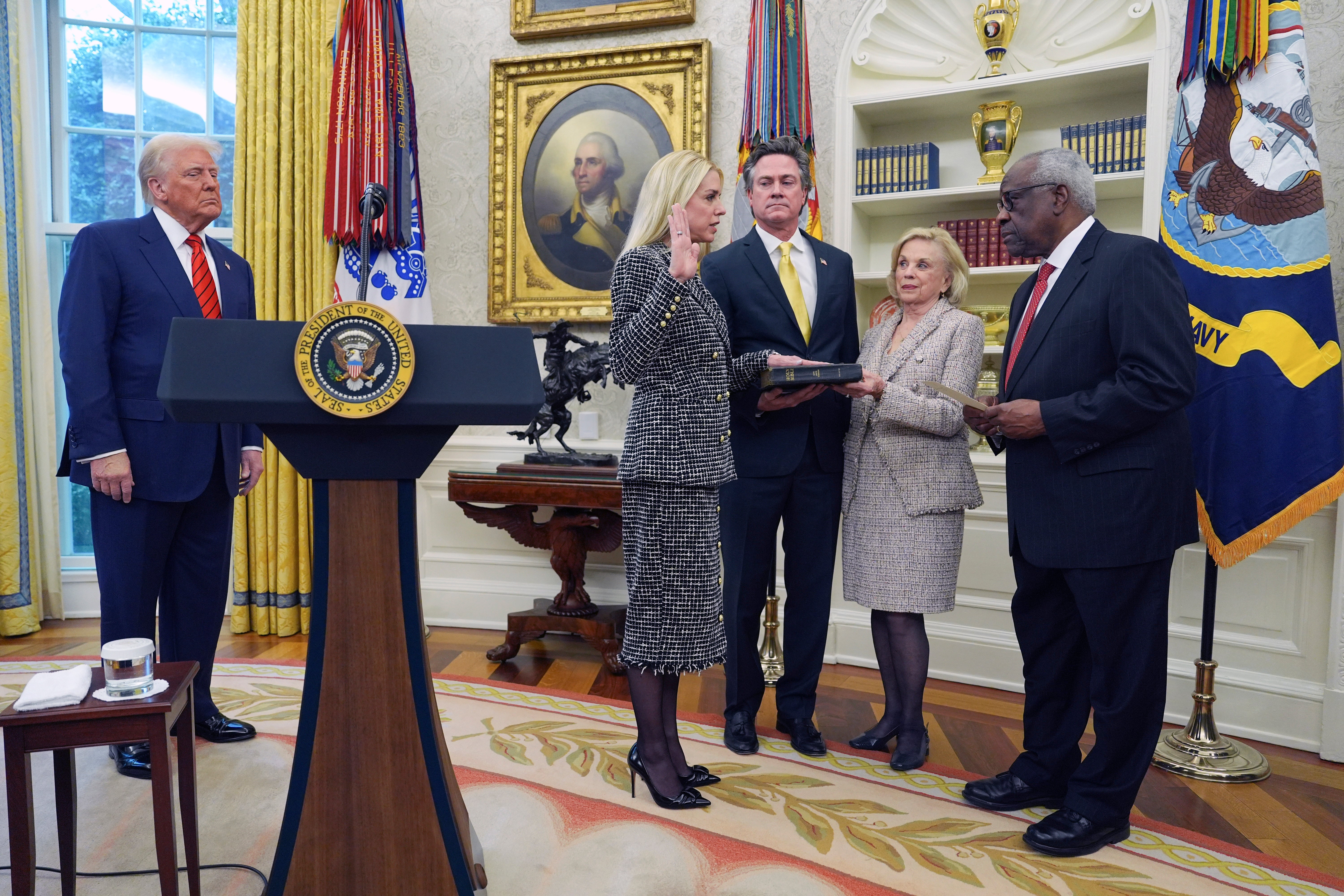 Bondi is sworn in as attorney general by supreme court associate justice Clarence Thomas, right, as Trump, her partner John Wakefield and mother Patsy Bondi look on