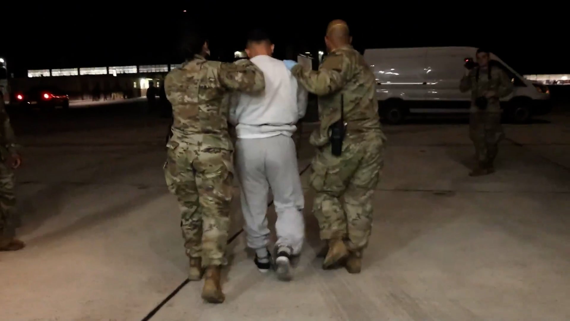 The Trump administration has sent flights of ‘criminal’ migrants to the notorious detention center and military base at Guantánamo Bay. New video from the government shows people being escorted on the base
