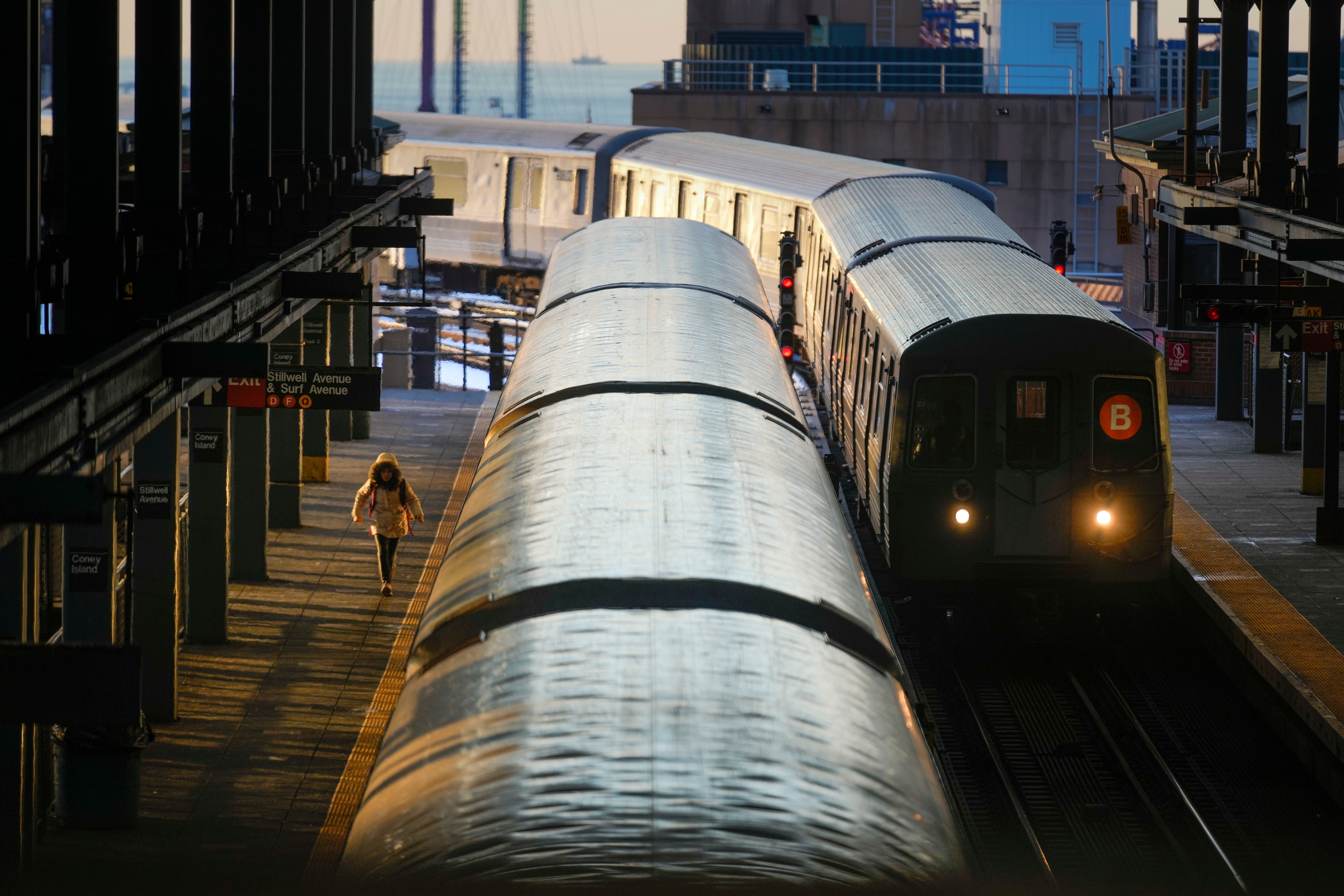 Trains arrive and depart a station in Coney Island