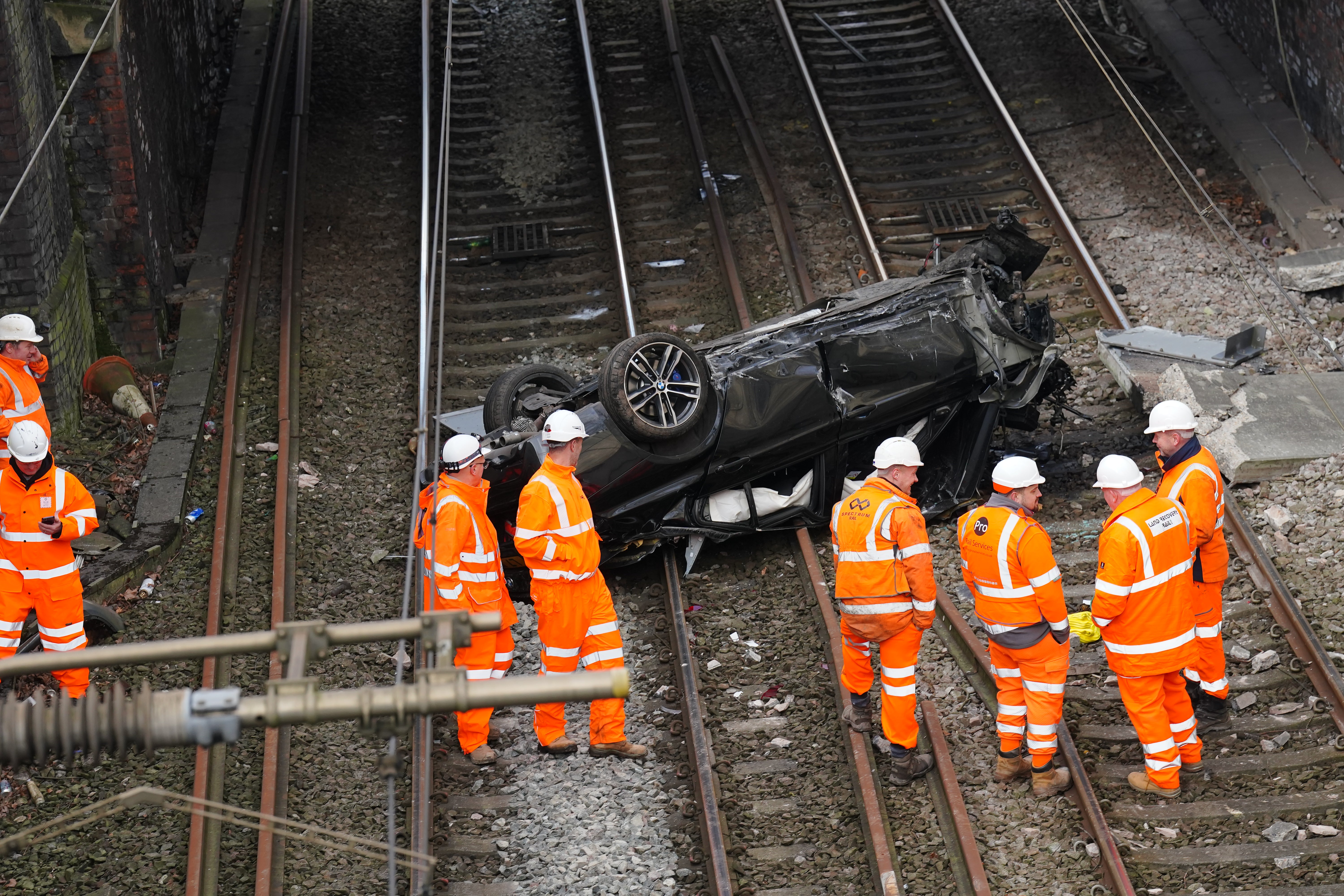 Emergency engineers set to work on removing the car and its debris from the tracks