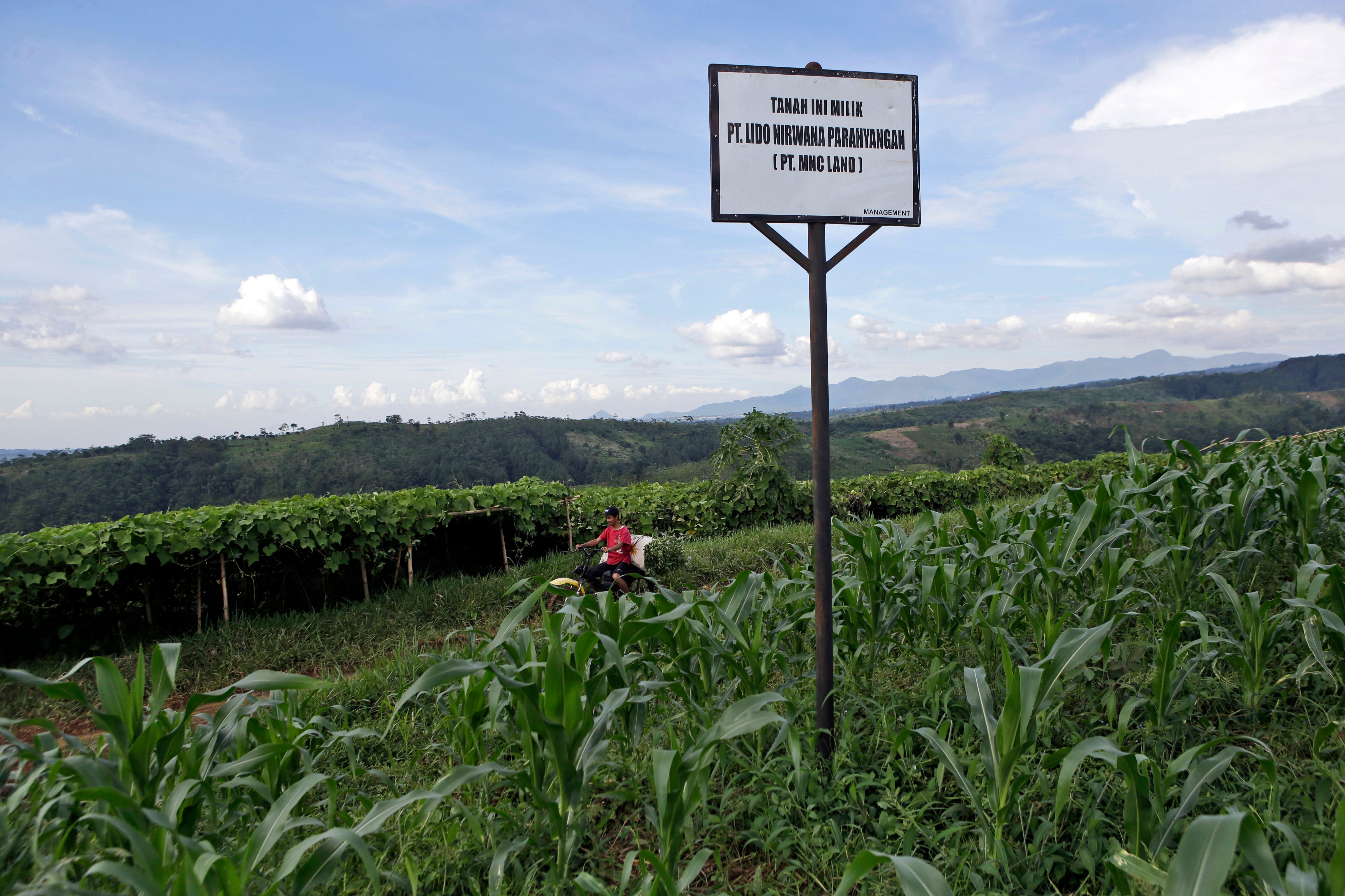 A sign saying the land is owned by MNC Land is put up on a farming field at the planned development site of a tourism project affiliated with U.S. President Donald Trump, near Gunung Gede Pangrango National Park in Bogor, West java, Indonesia