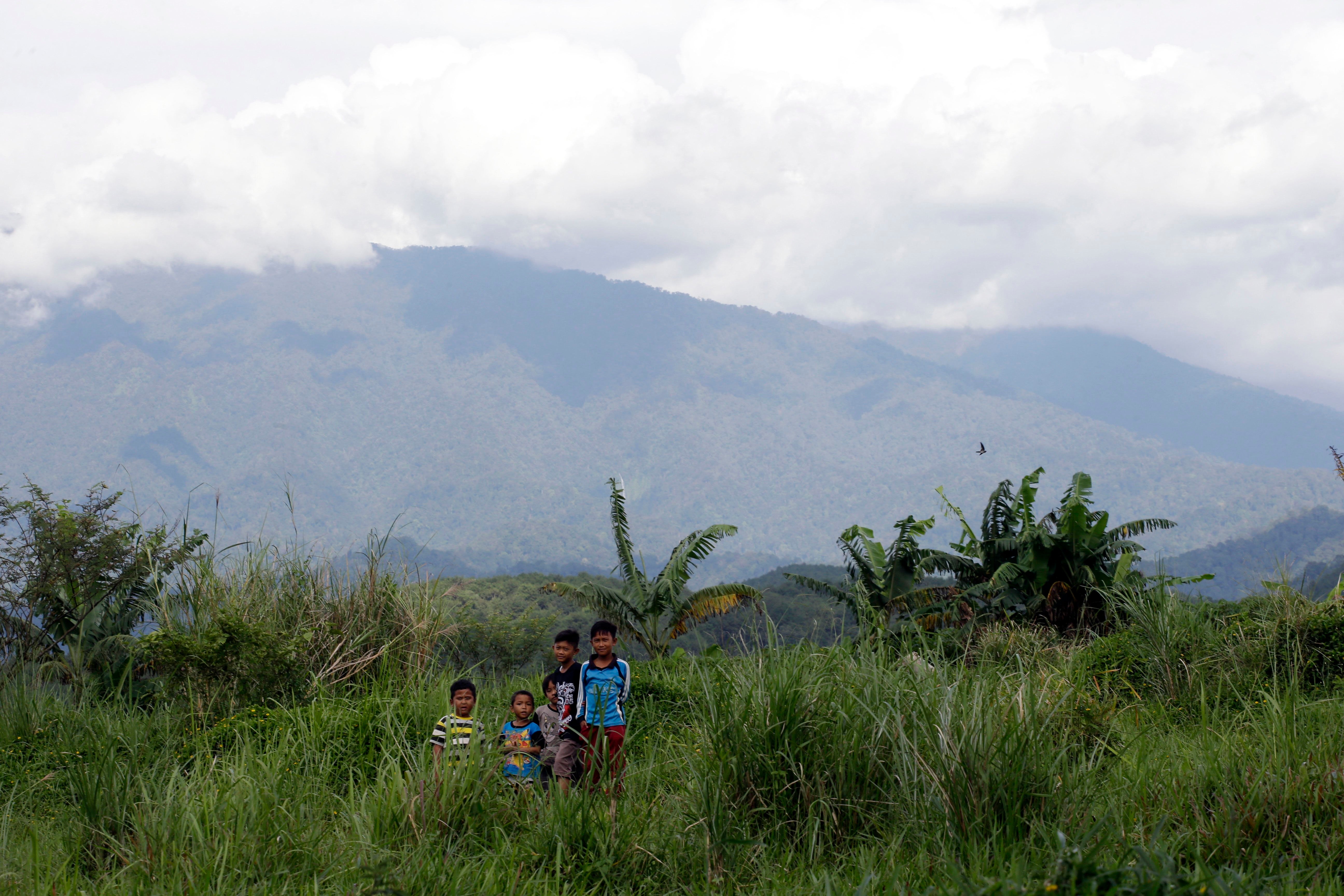 Children stand on a field at the planned development site of a tourism project affiliated with U.S. President Donald Trump