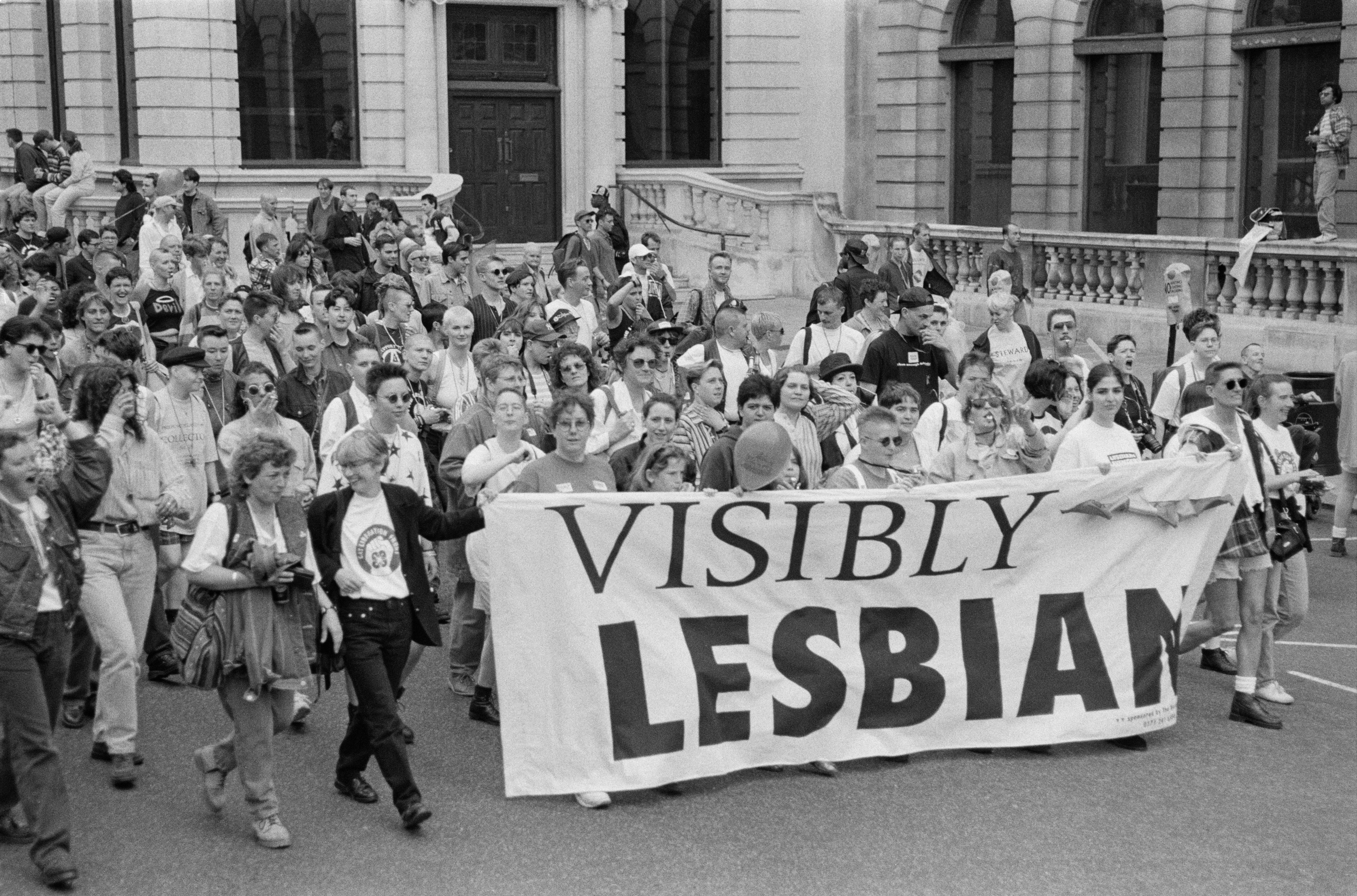 Marchers carrying a banner with the words ‘Visibly Lesbian’, at the Lesbian and Gay Pride event, London, 1995