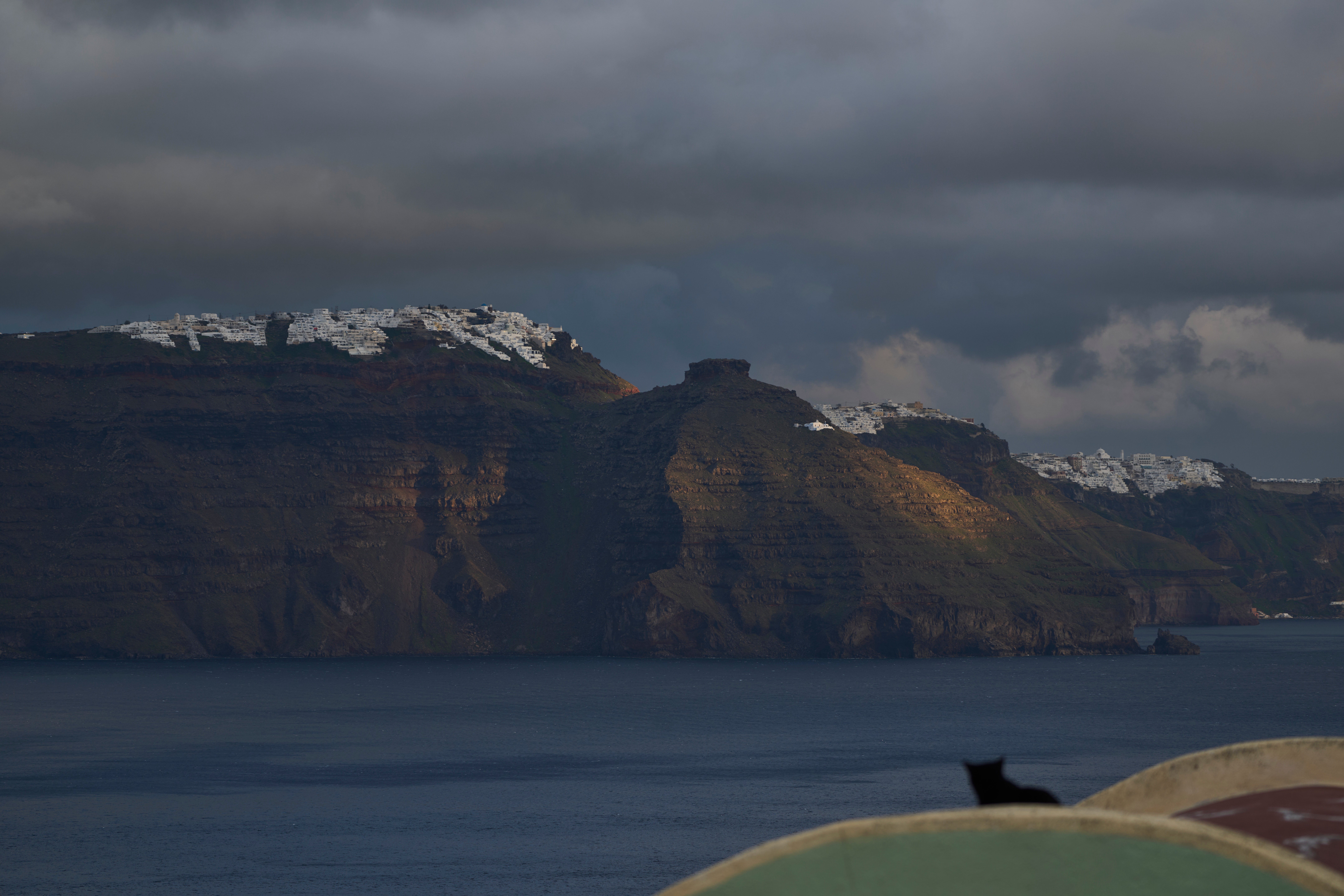 A cat sits on a domed roof in the town of Oia on the earthquake-struck island of Santorini