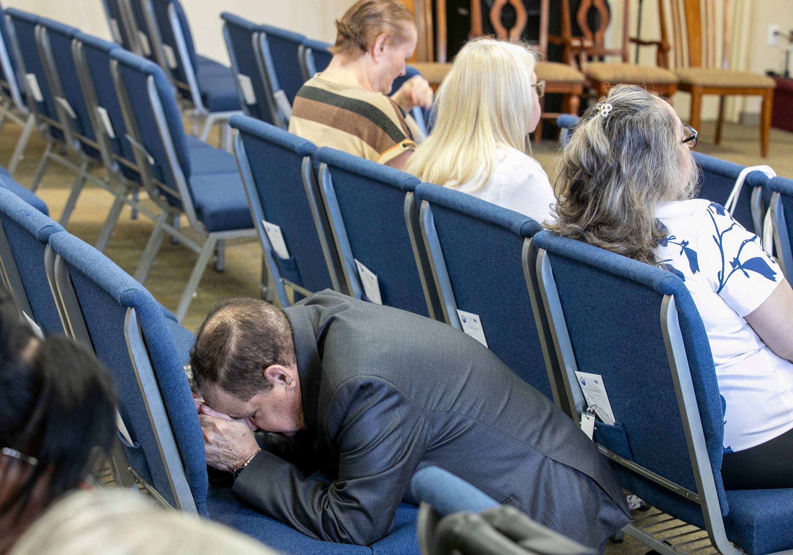 A congregant kneels in prayer at the Centro Cristiano El Pan de Vida, a mid-size Church of God of Prophecy congregation, in Kissimmee, Florida