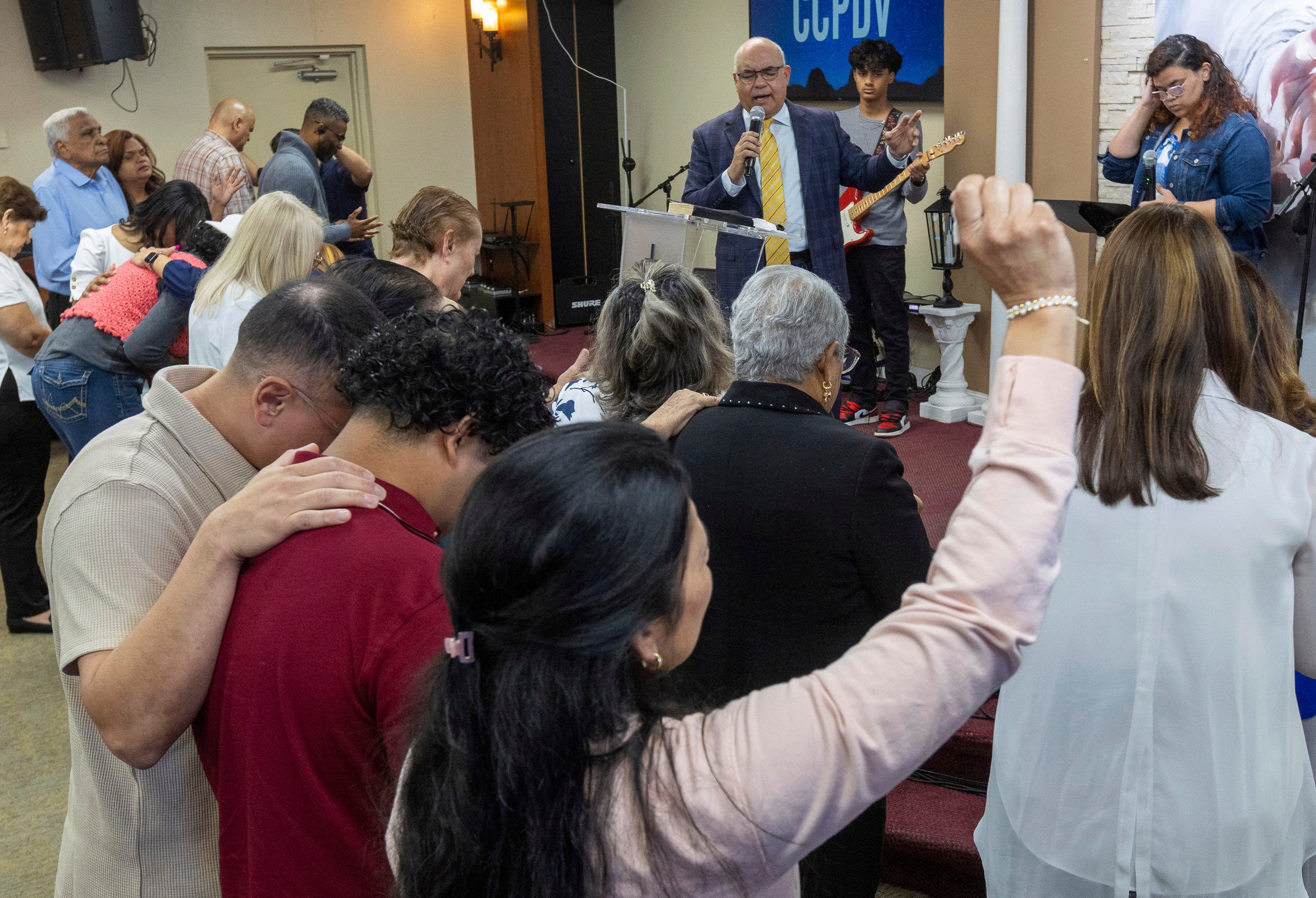 Rev. Esteban Rodriguez leads his congregants in prayer at the Centro Cristiano El Pan de Vida, a mid-size Church of God of Prophecy congregation, in Kissimmee, Florida