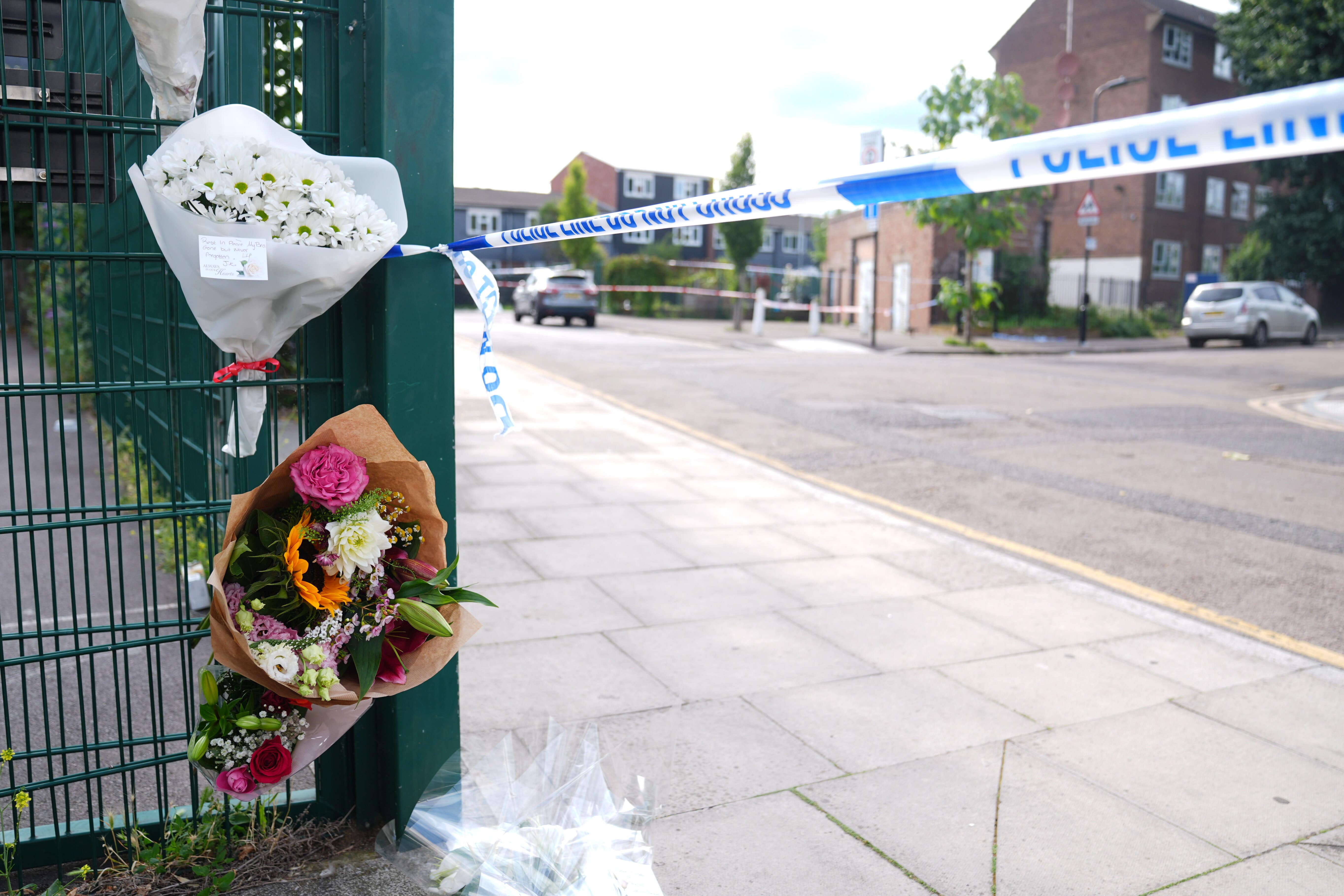 Flowers near to the scene in Stellman Close in Hackney (PA)