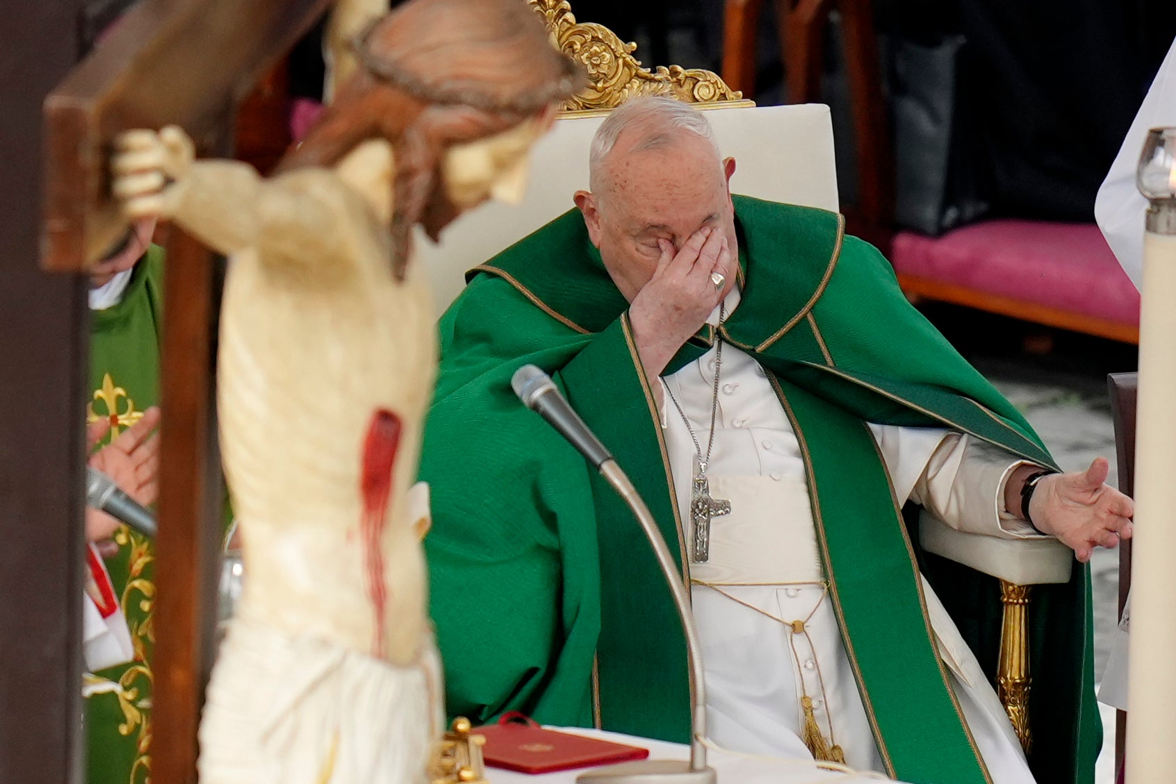 Pope touches his eyes as he presides over a mass for the jubilee of the armed forces in St. Peter’s Square at The Vatican
