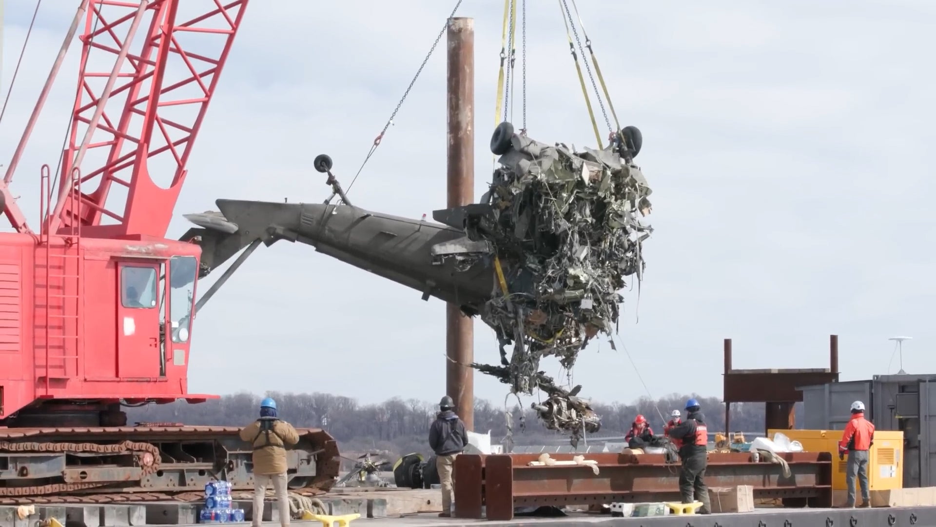 Investigators recover the tail of the Black Hawk helicopter from the Potomac River