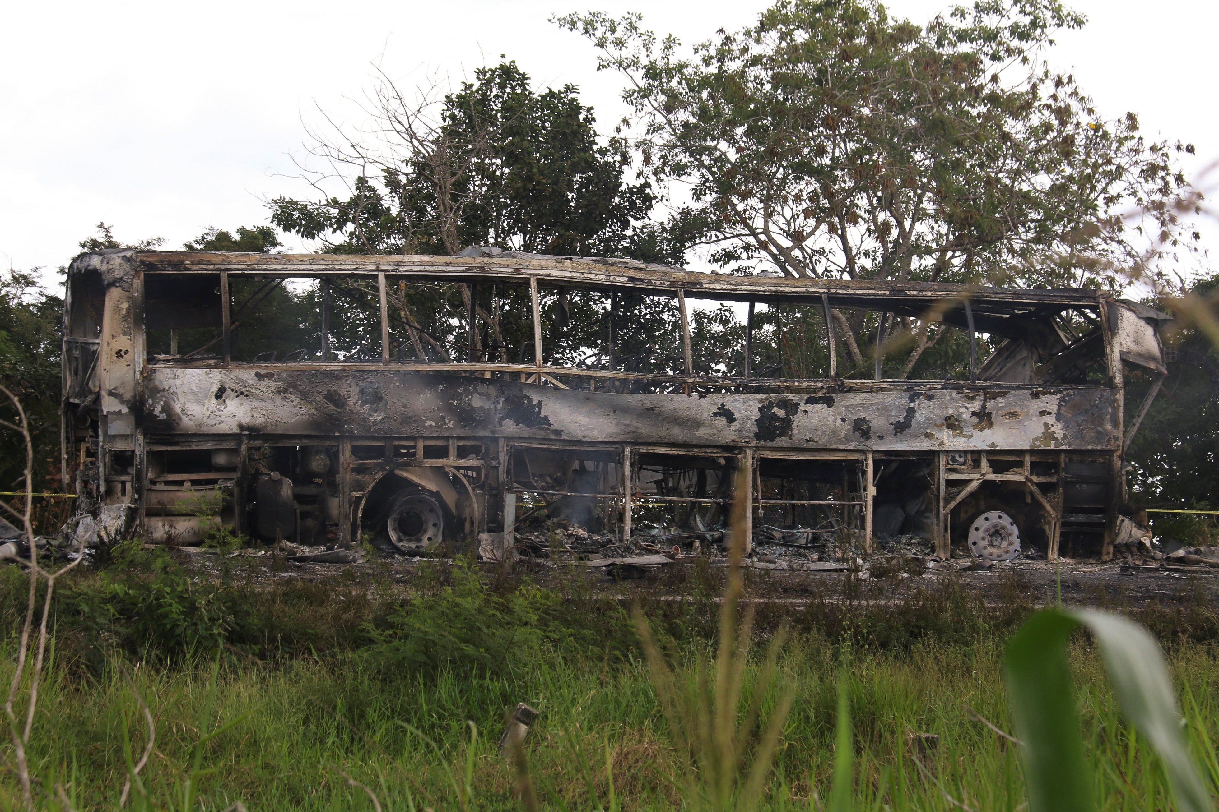 A burned bus is pictured after colliding with a trailer during its journey from Cancun to Tabasco, where people died in the accident, according to local media, near Escarcega, Campeche state in southern Mexico