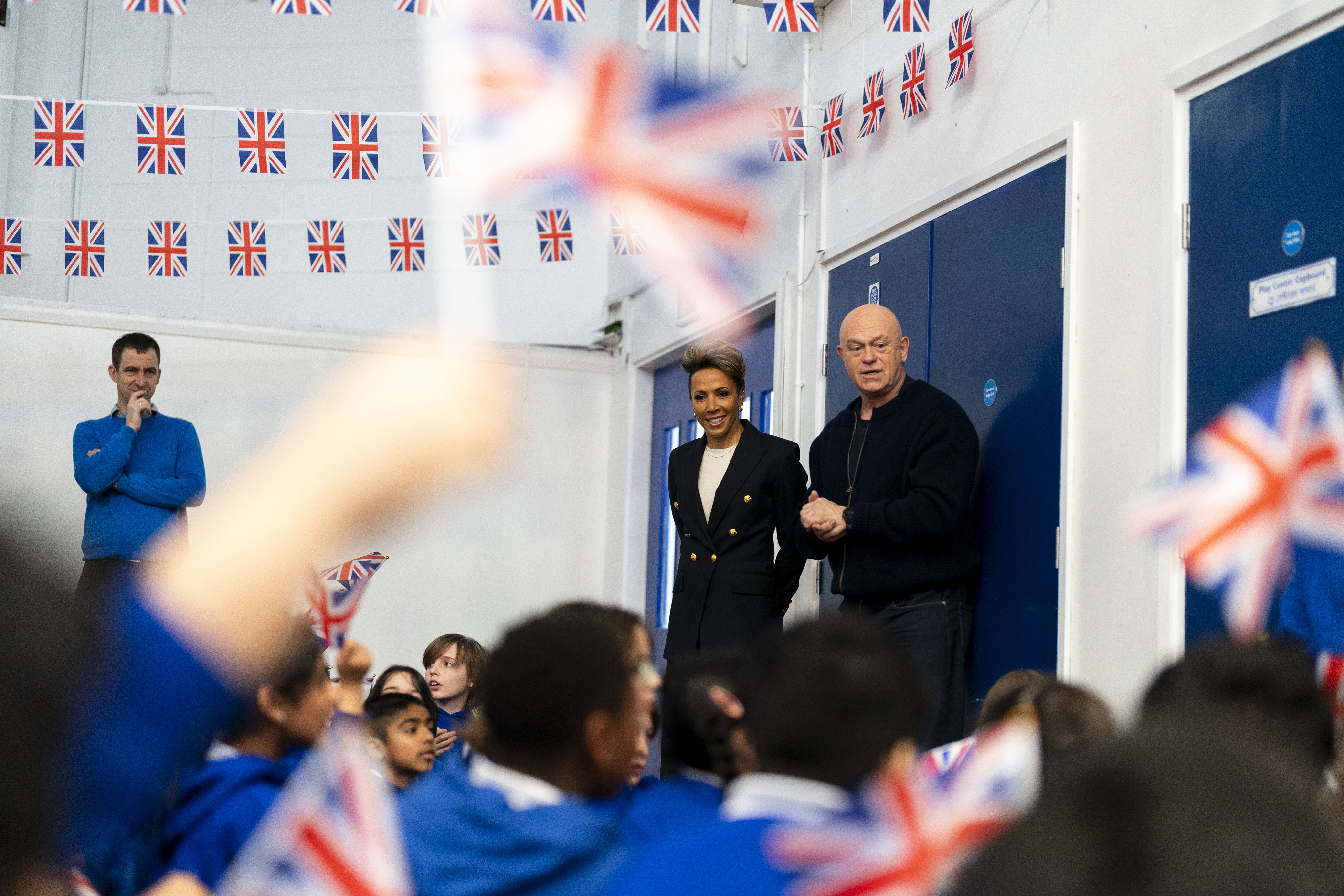 Primary school children greet Ross Kemp and Dame Kelly Holmes to launch VE Day 80 at Hermitage Primary School in London (Jordan Pettitt/PA)