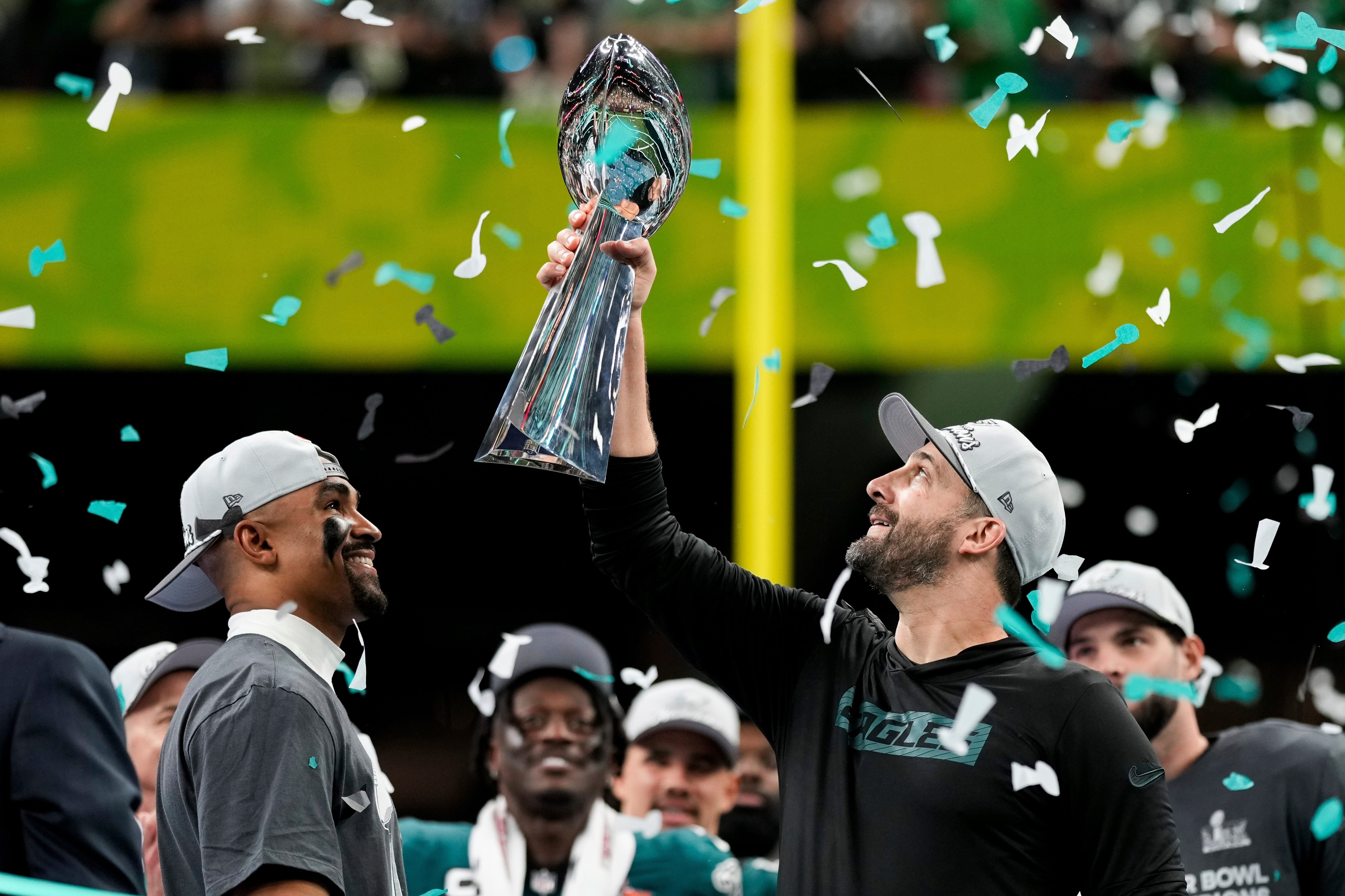 Philadelphia Eagles head coach Nick Sirianni, right, lifts the Vince Lombardi Trophy next to quarterback Jalen Hurts (Matt Slocum/AP)