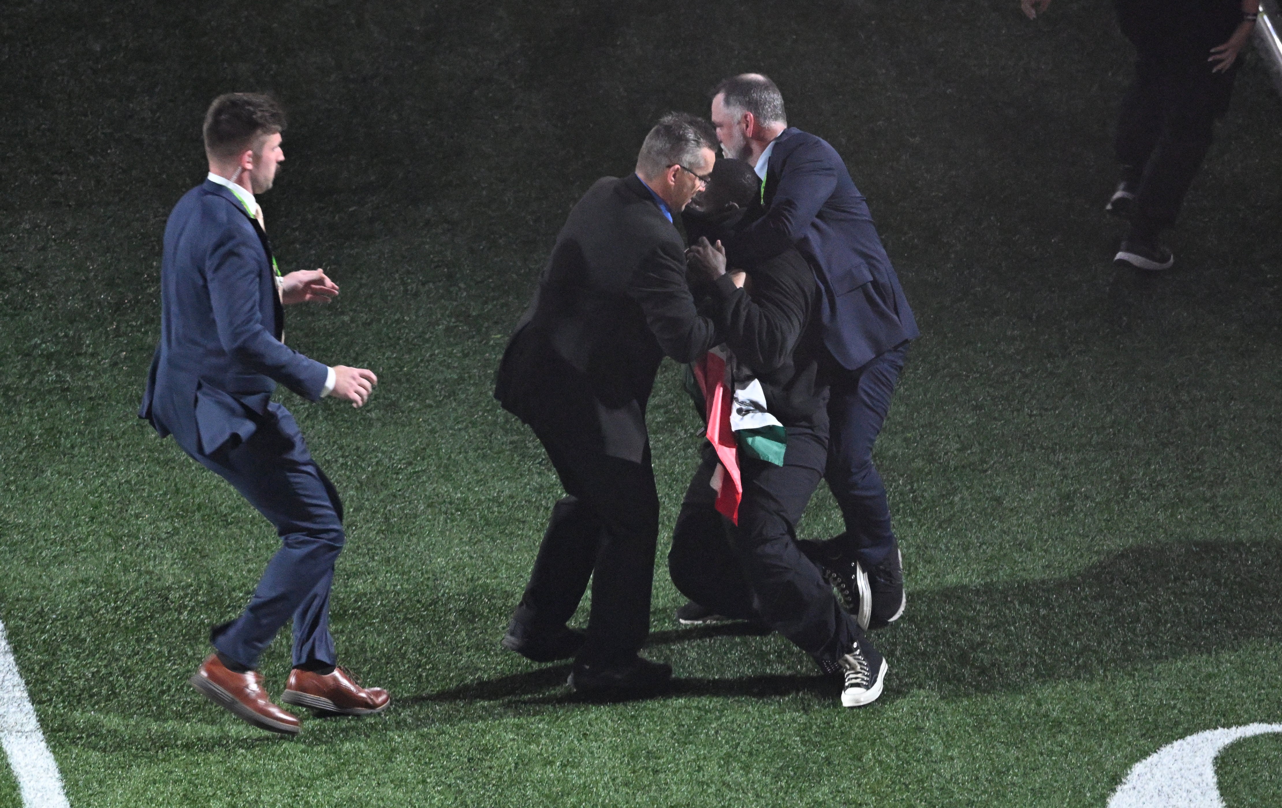 Nantambu was tackled by several men in suits after running off stage with a ‘Sudan and Free Gaza’ flag