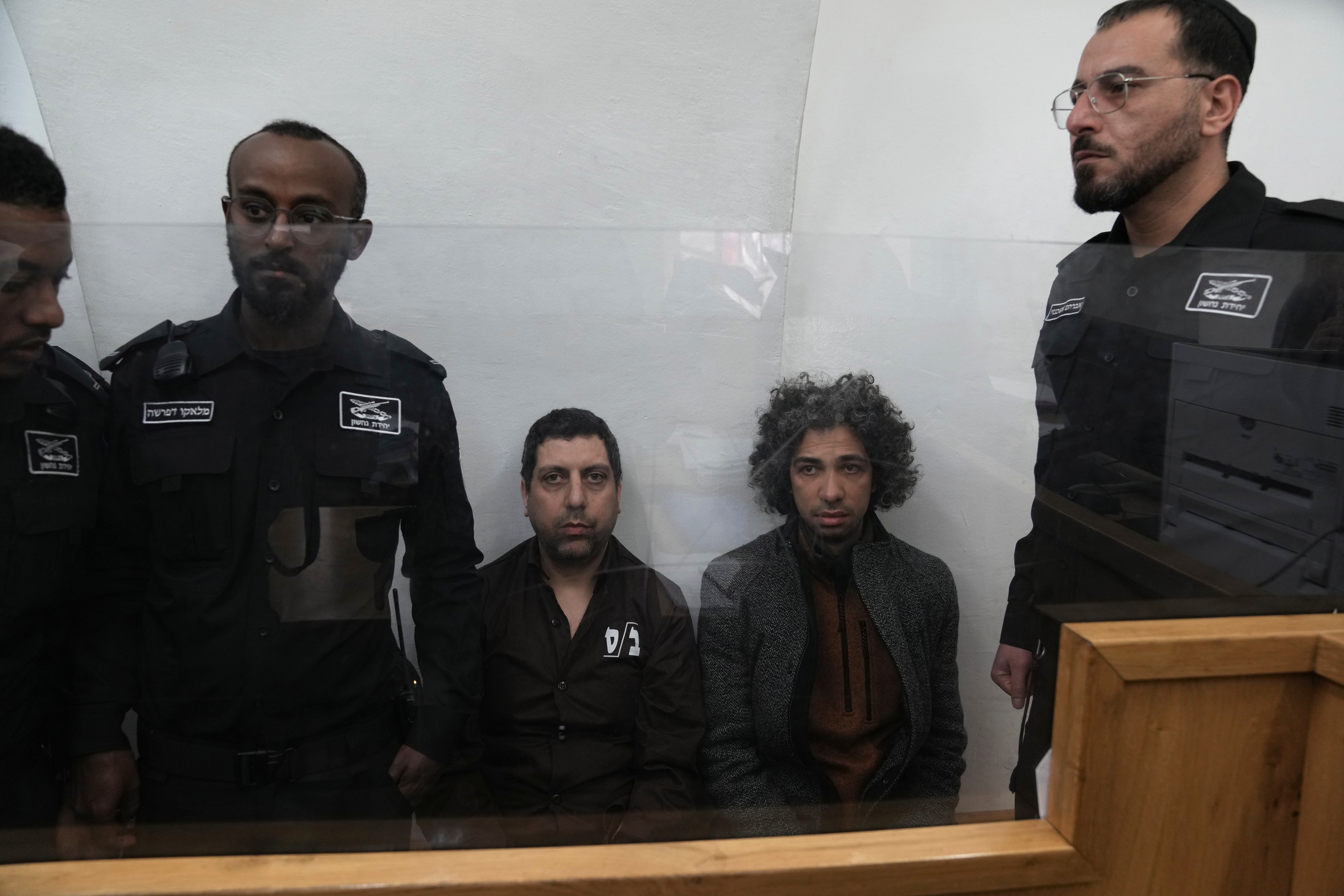 Booksellers Ahmad, left, and Mahmoud Muna appear in court after the raid on the Educational Bookshop