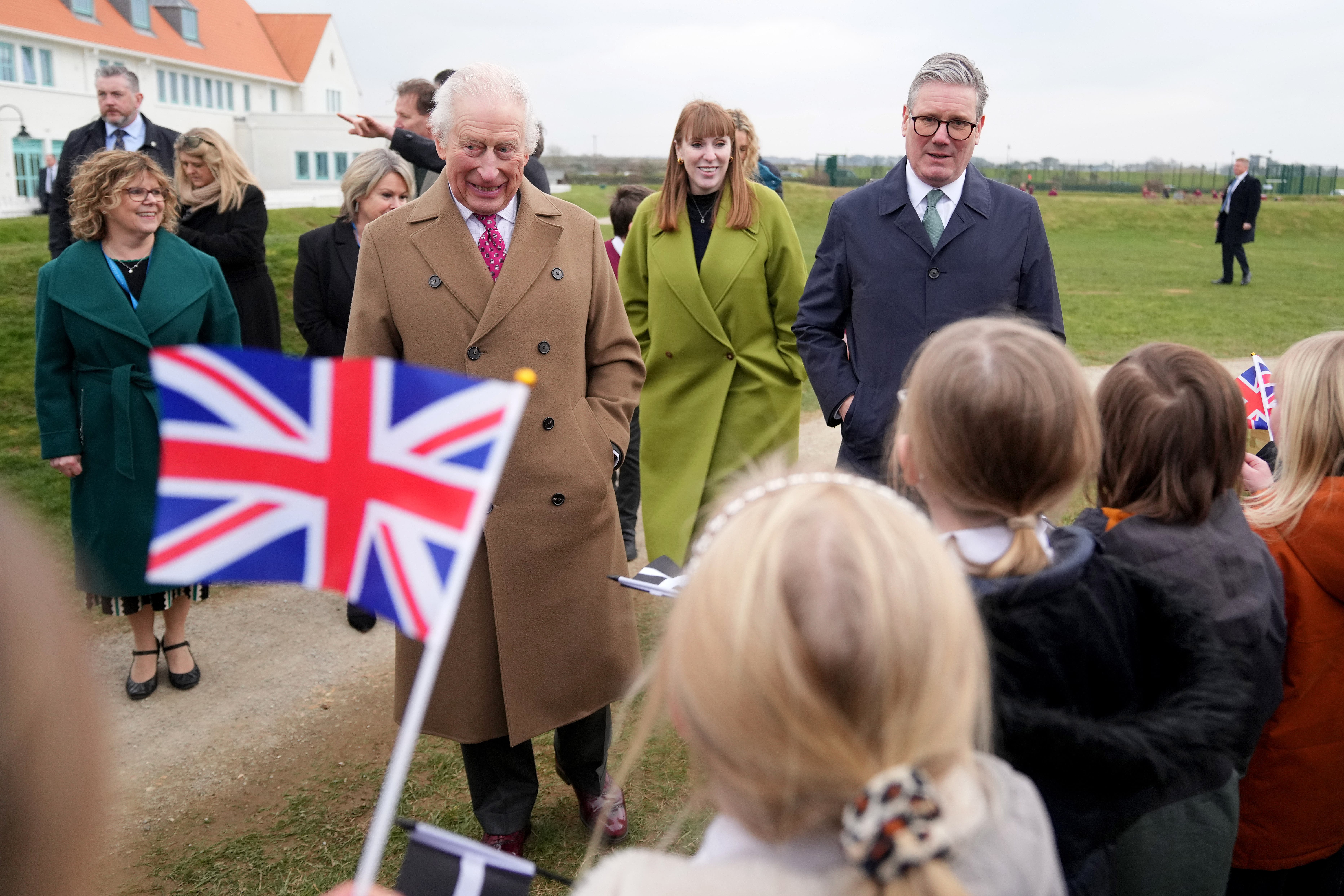 The King accompanied by Prime Minister Sir Keir Starmer and Deputy Prime Minister Angela Rayner during a visit to Nansledan School in Newquay (Alastair Grant/PA)