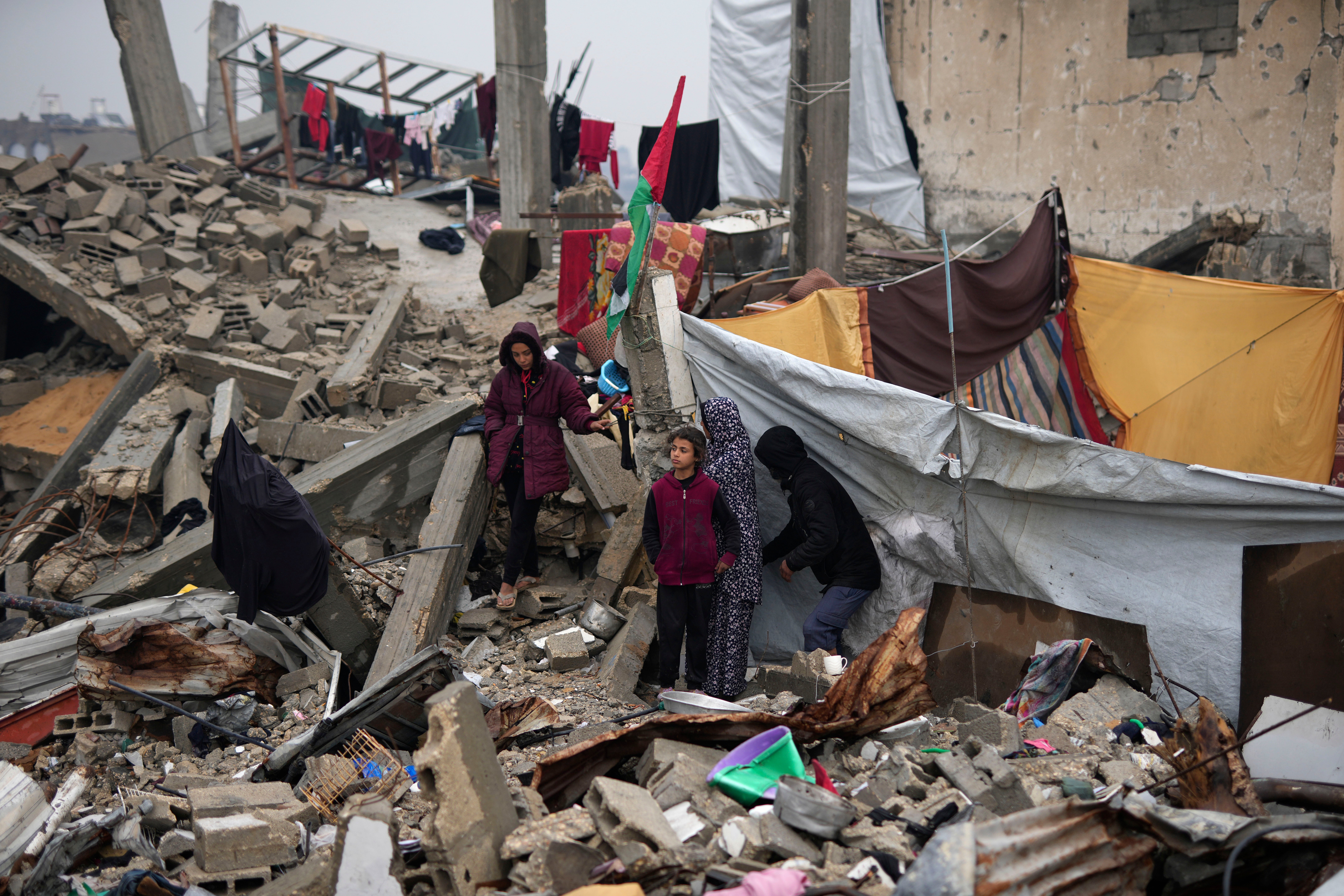 The Rehan family in their encampment in the ruins of their home in Jabaliya, Gaza Strip, Monday, Feb. 10, 2025. (AP Photo/Abdel Kareem Hana)