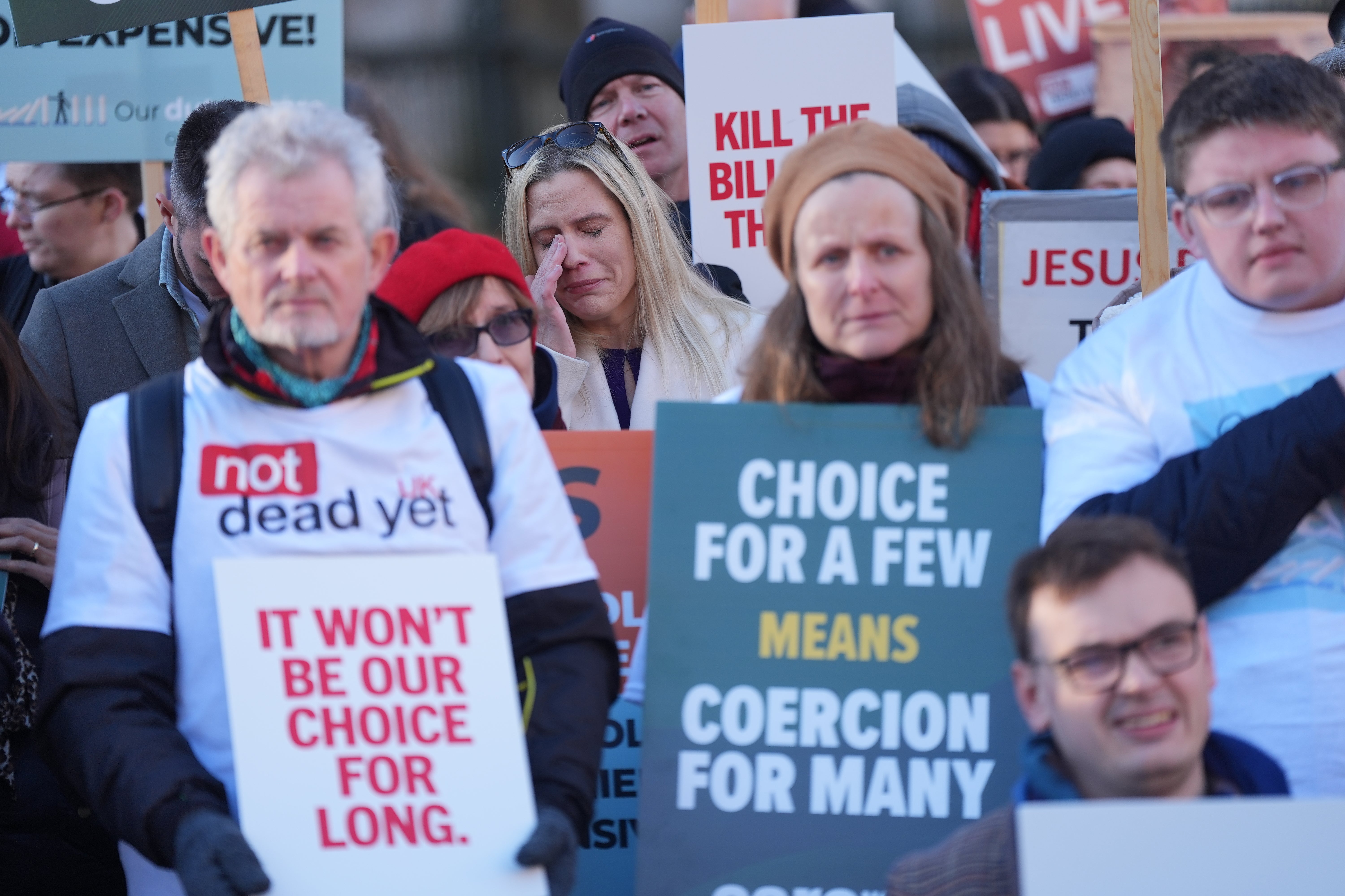 People take part in a demonstration at Old Palace Yard in Westminster, London, to oppose the assisted dying bill
