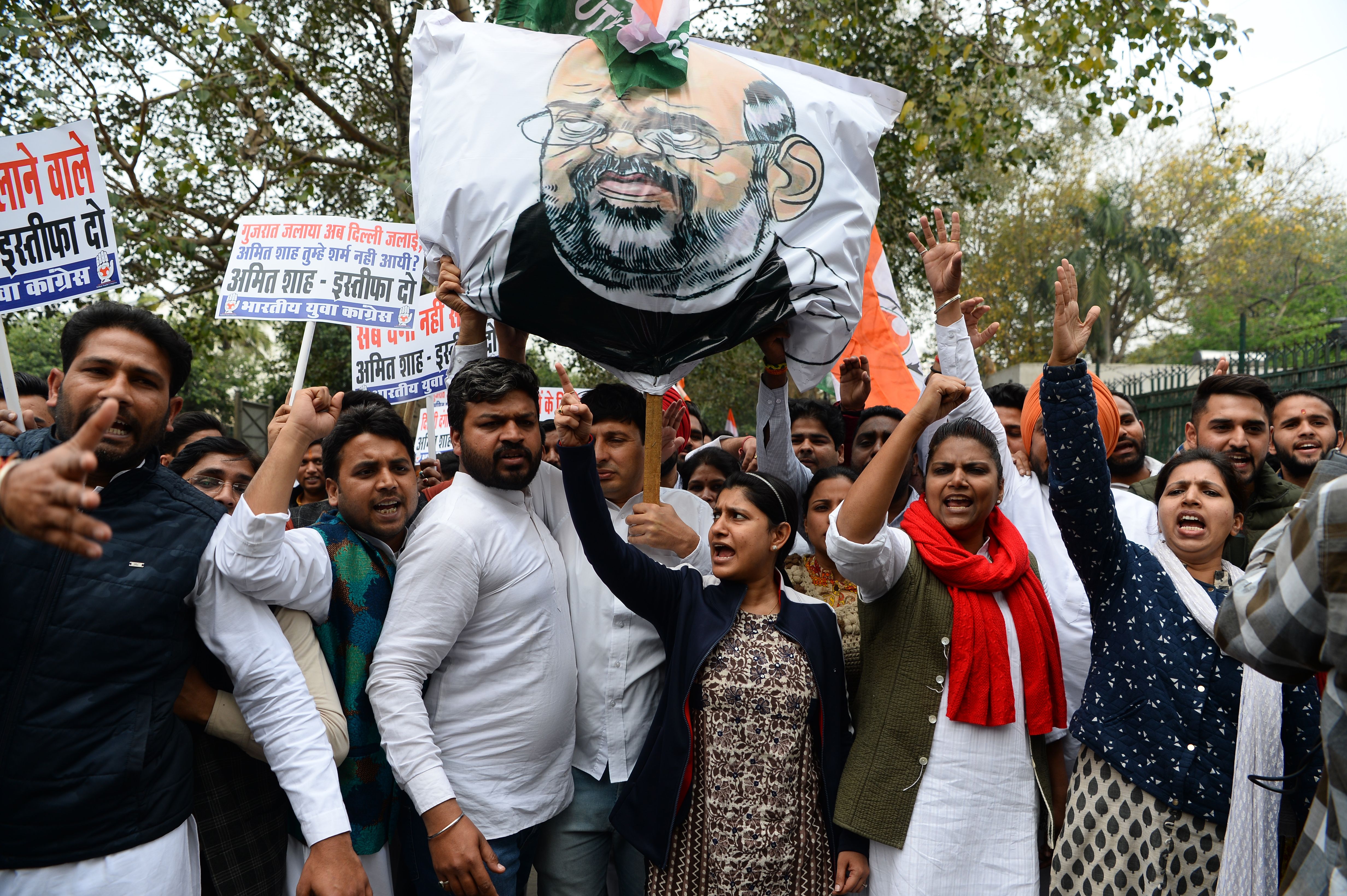File. Indian Youth Congress activists shout slogans next to an effigy of home minister Amit Shah during a protest demanding his resignation for the hate speeches over sectarian riots in India’s capital, near the Parliament in New Delhi on 2 March 2020