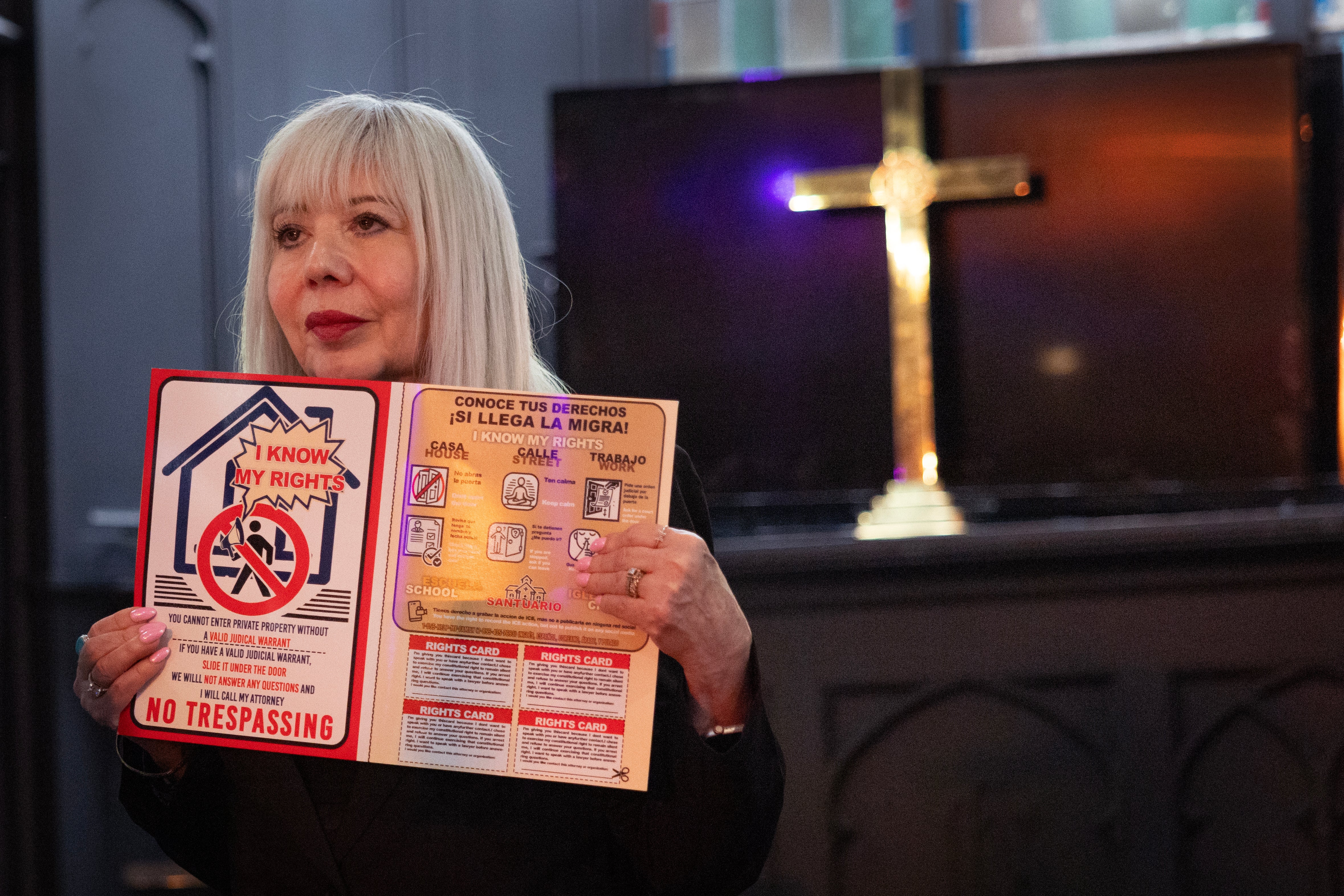 The Rev. Emma Lozano holds up a card stating the legal rights immigrants should know during a Spanish language service at Lincoln United Methodist Church in Chicago on February 2