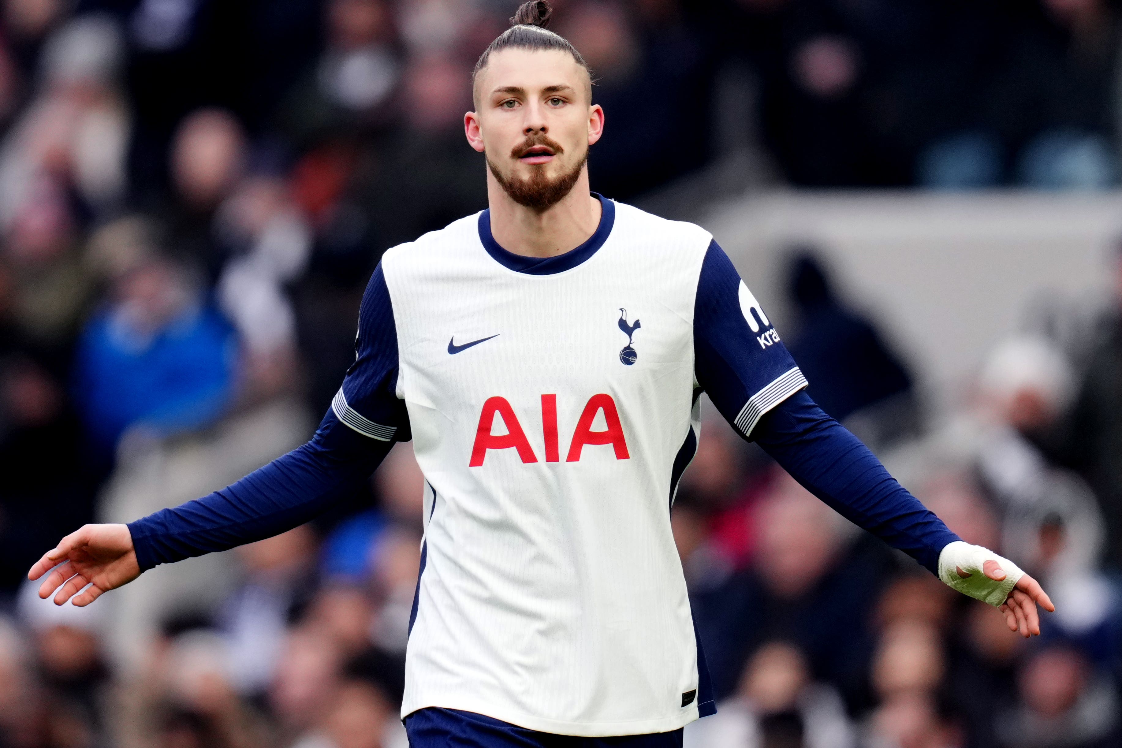 Tottenham defender Radu Dragusin is set for a lengthy spell of rehabilitation (John Walton/PA)